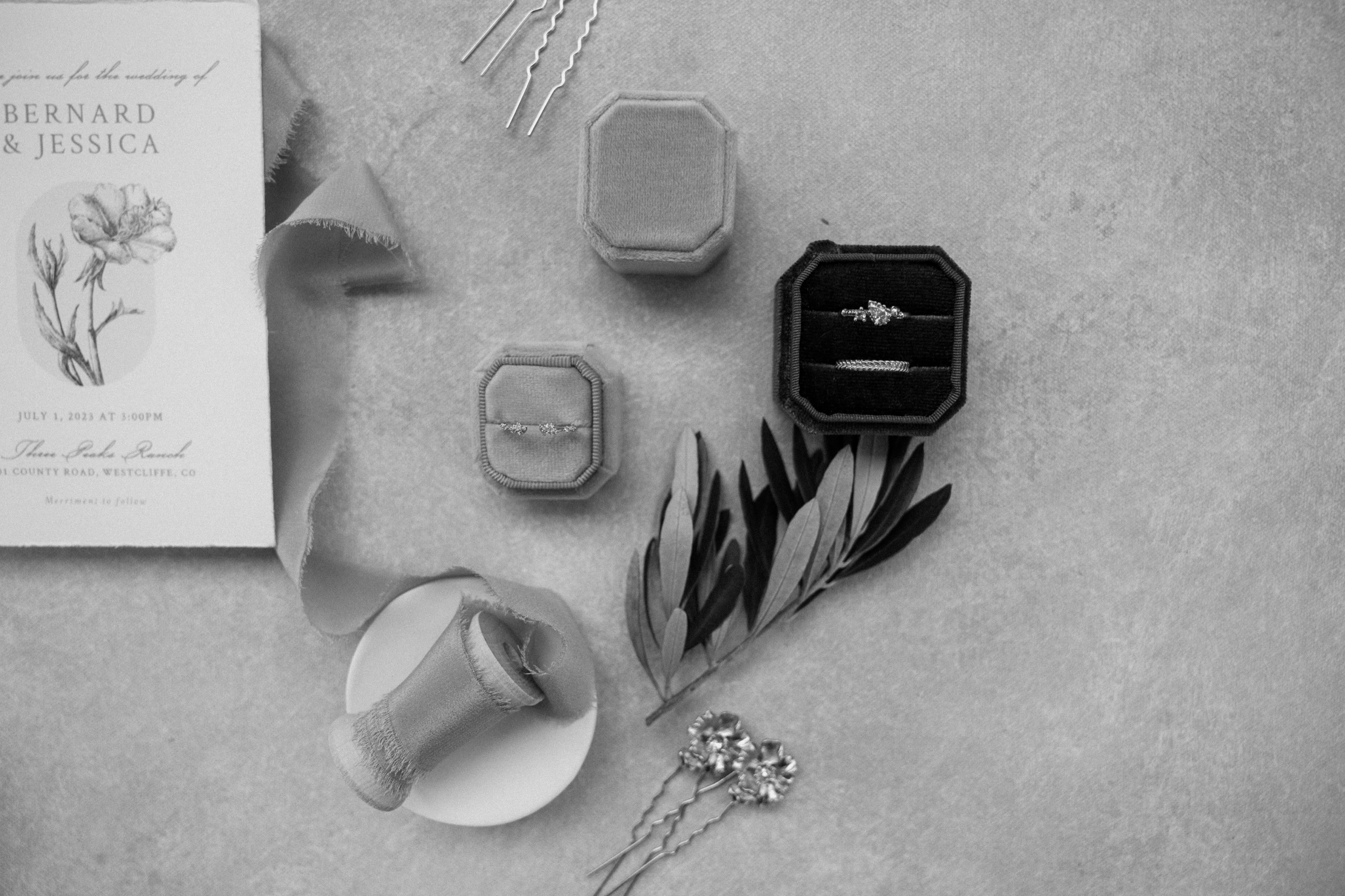 A black and white photo of wedding details for Jessica and Bernards wedding at Three Peaks Ranch. Photo by Ashley Joyce