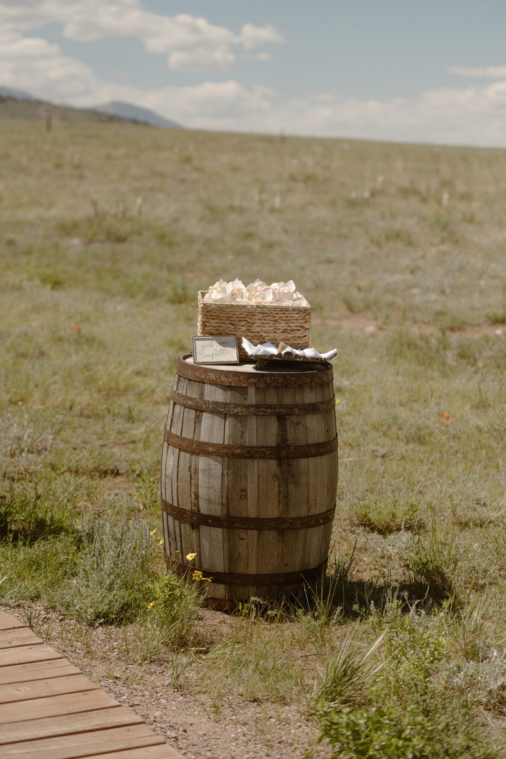 A photo of a wooden barrel with wedding details on top at Three Peaks Ranch. Photo by Ashley Joyce.