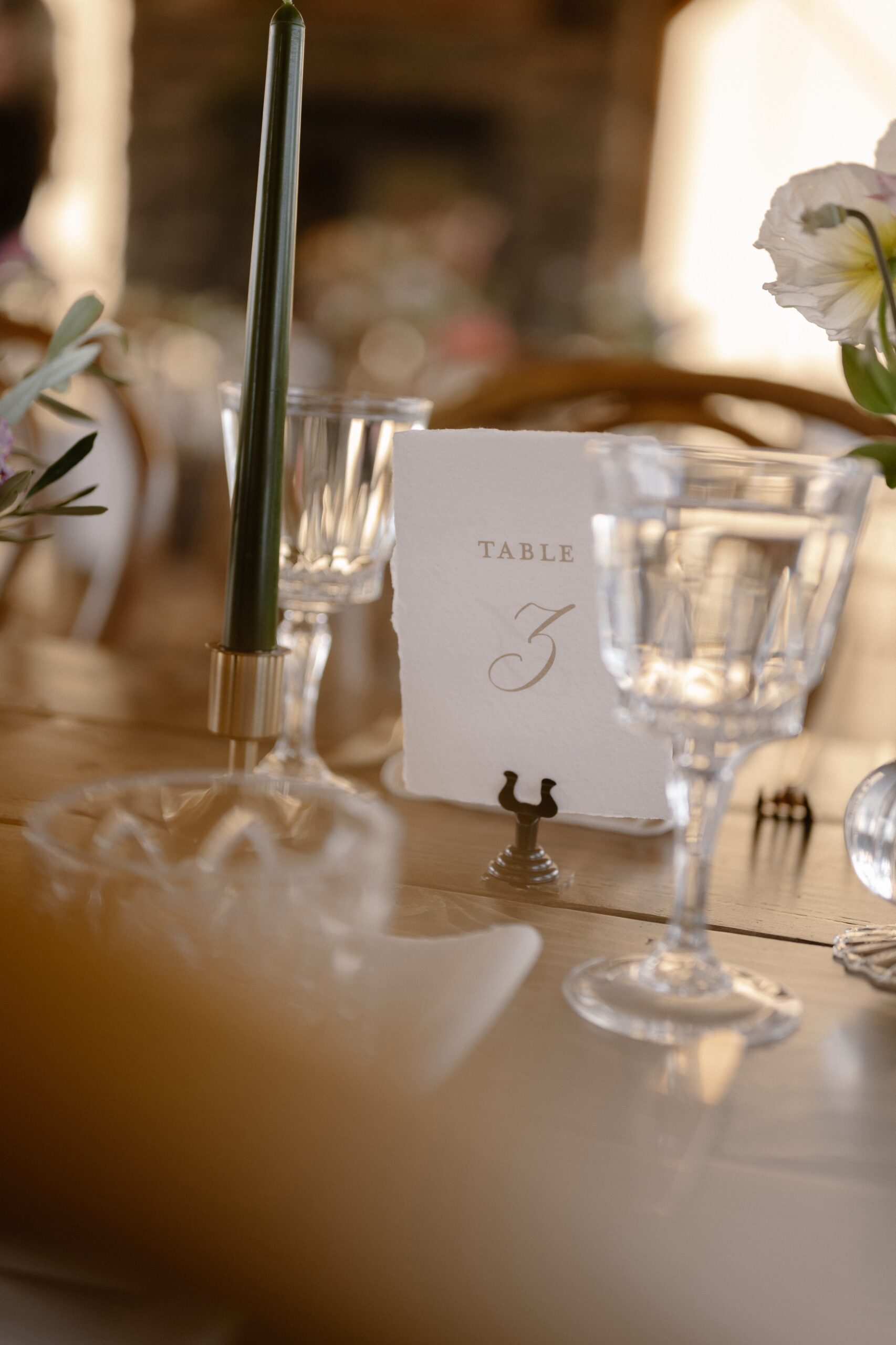 A photo of a table number card labeled "Table 3". Photo taken at Three Peaks Ranch by Ashley Joyce.
