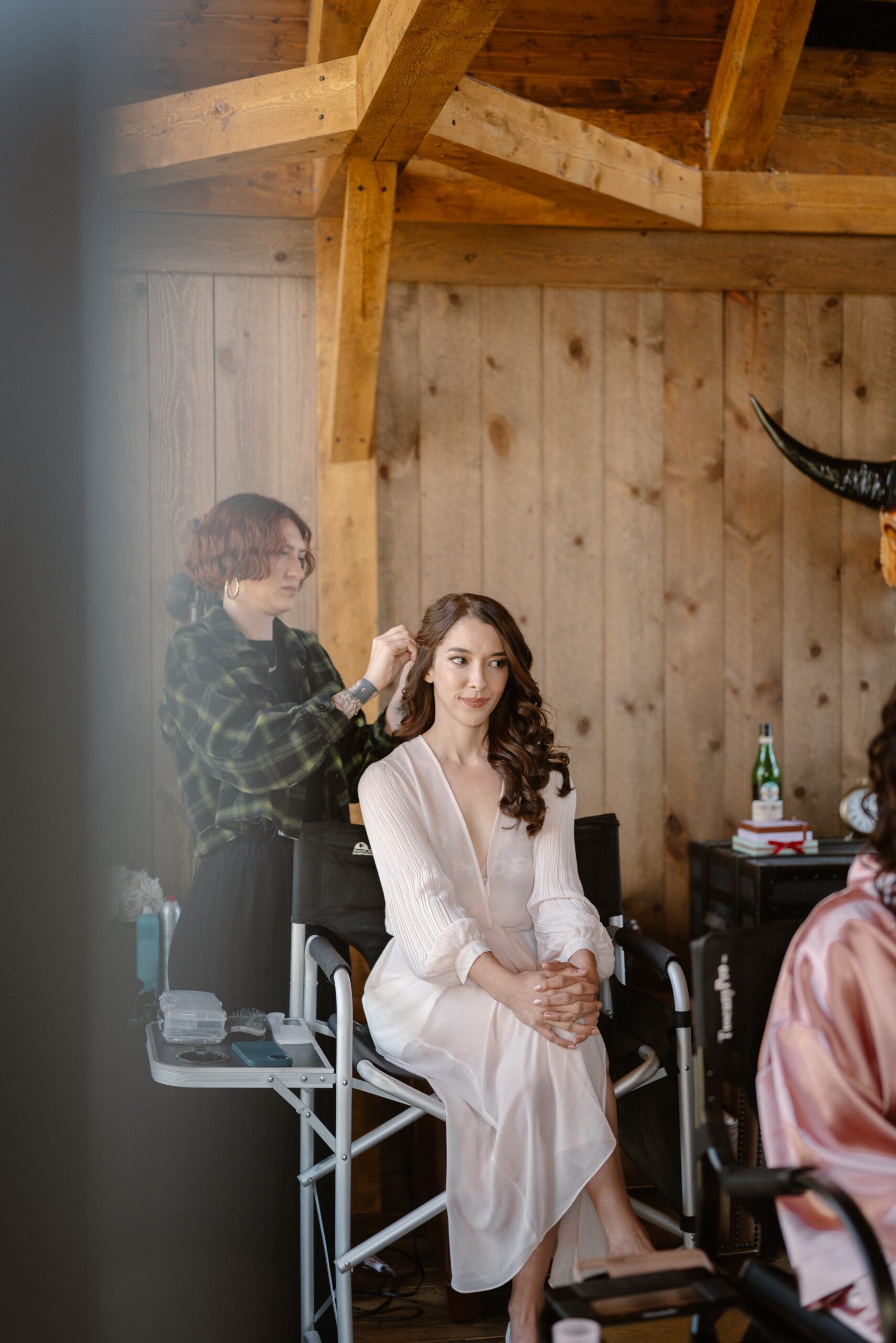 A bride gets her hair and makeup done. Photo by Ashley Joyce.