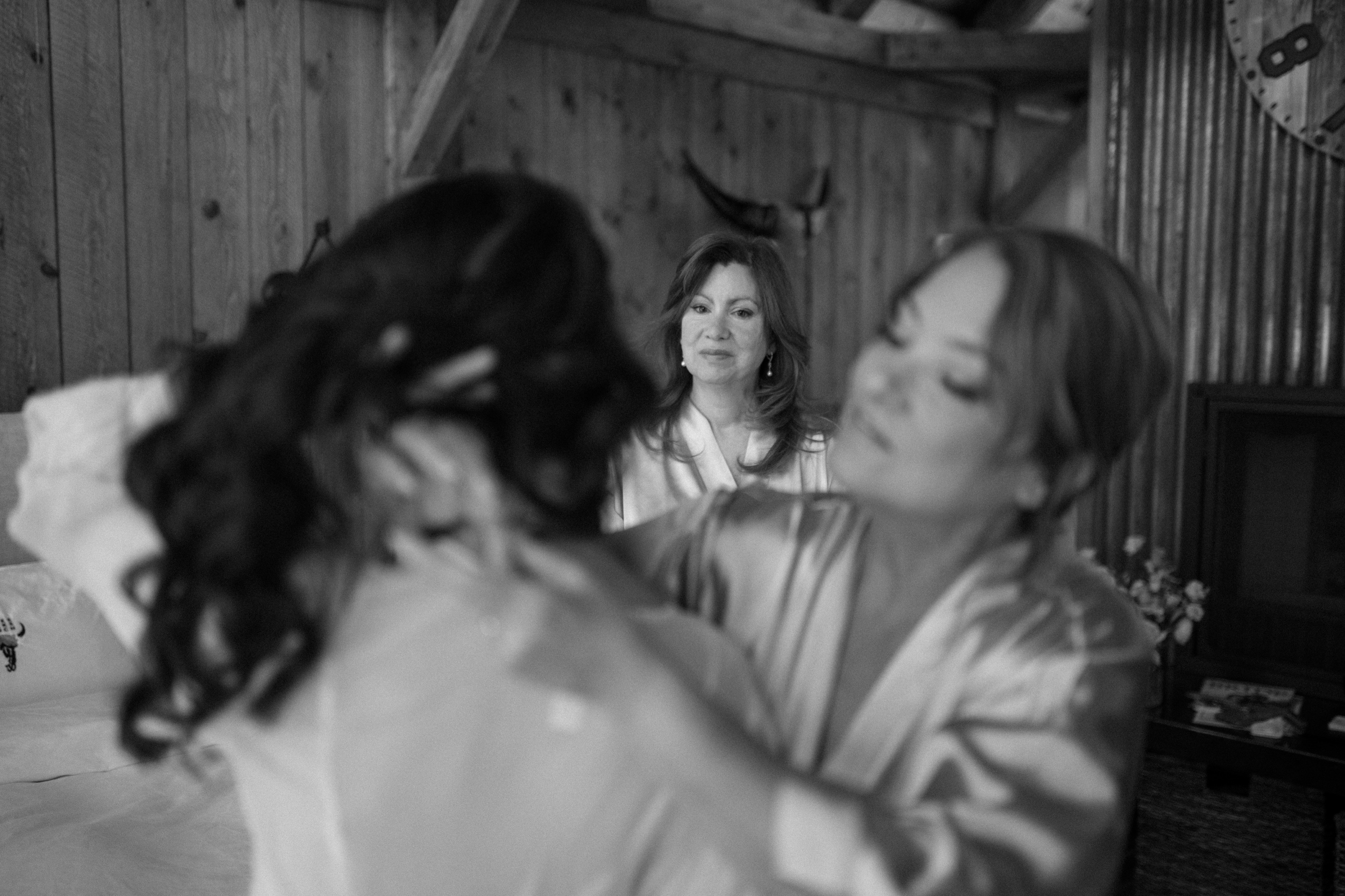 A family member looks lovingly at bride, Jessica, while she gets ready for her wedding. Photo by Ashley Joyce.