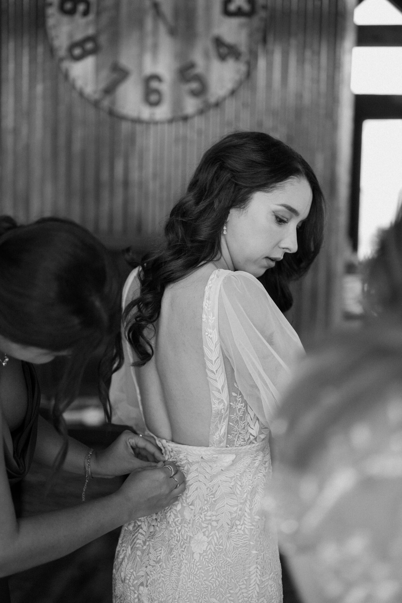 A black and white photo of a bride getting ready for her wedding at Three Peaks Ranch. Photo by Ashley Joyce.