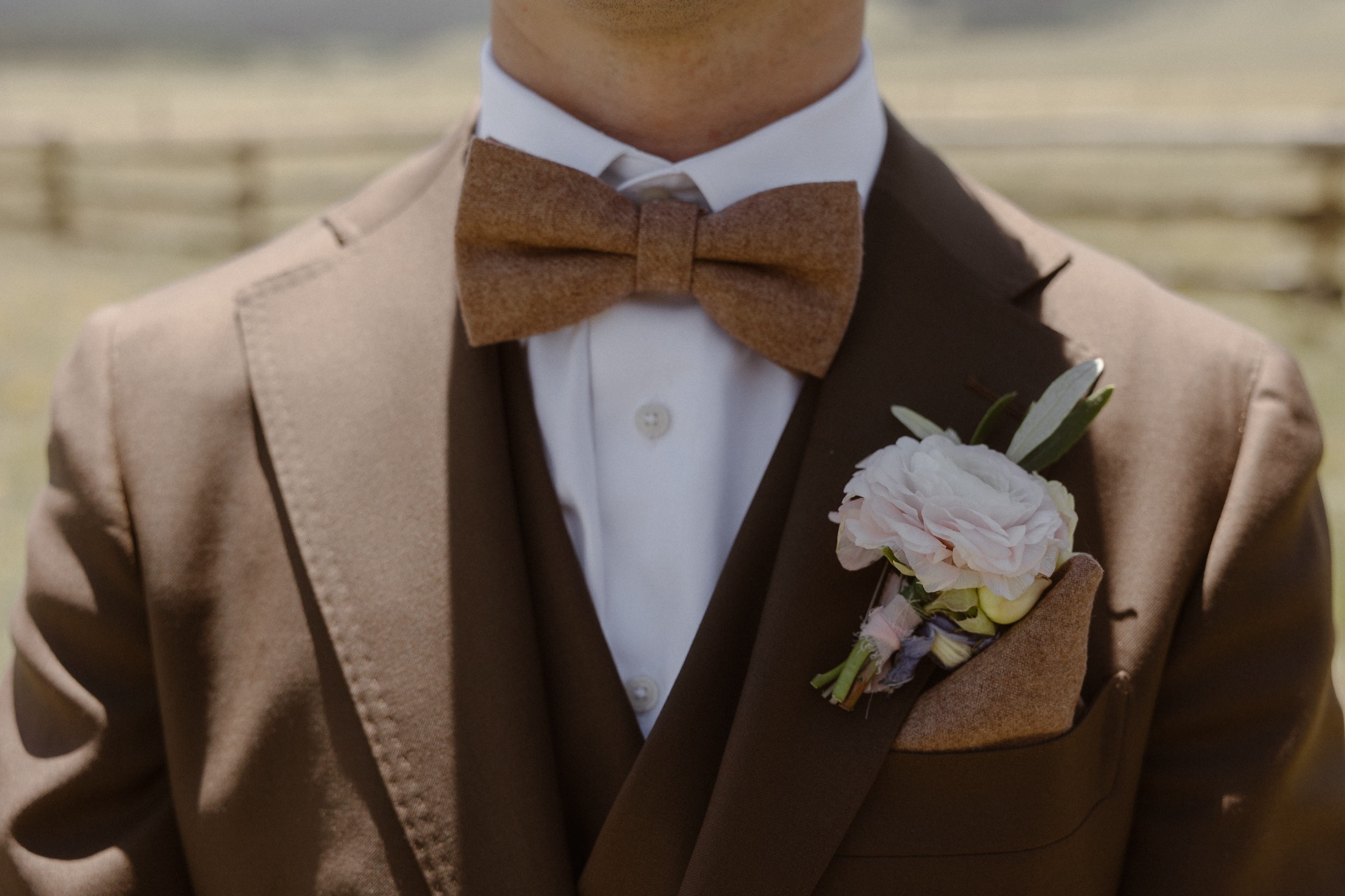 A closeup of a groom's bowtie and boutonniere. Photo by Colorado wedding photographer Ashley Joyce.