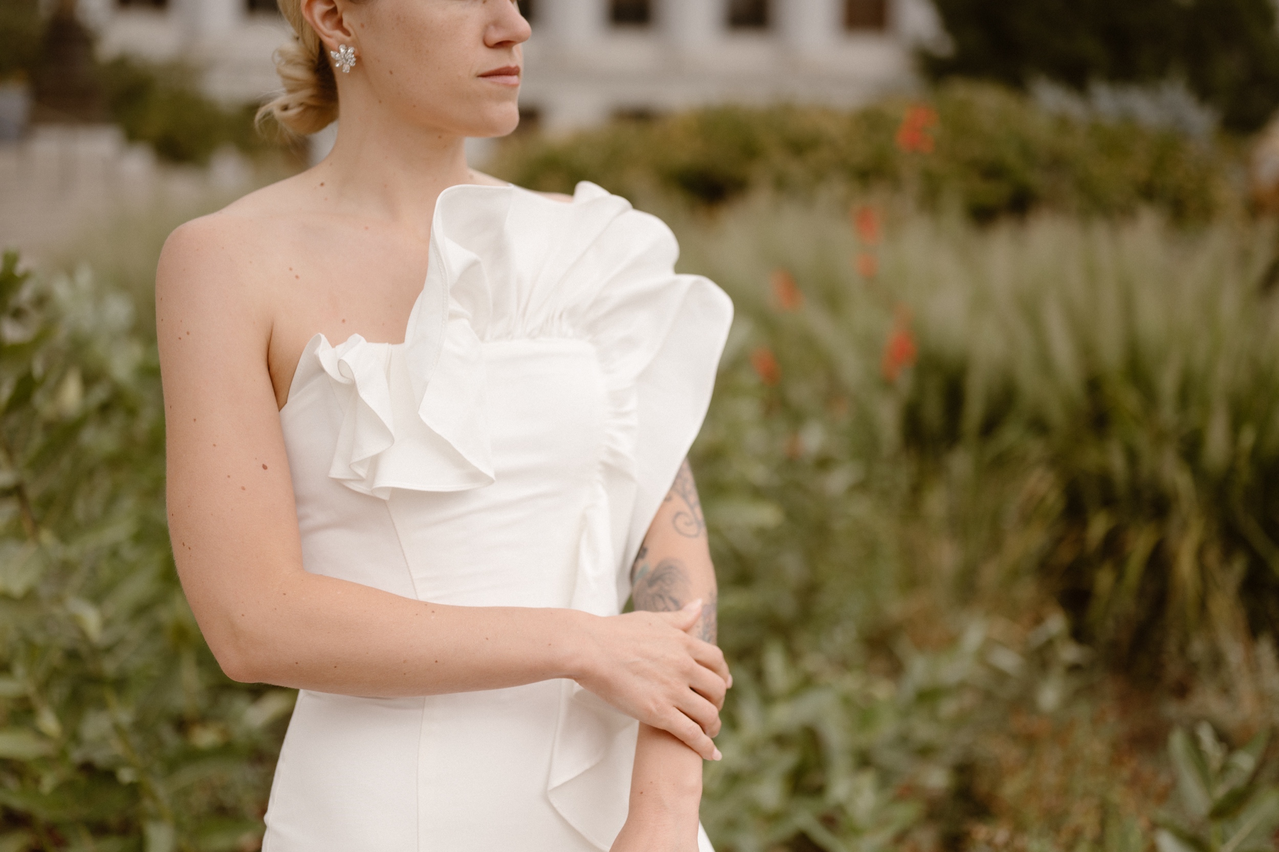 A bride poses for her wedding portraits in front of the Denver courthouse. Photo by Colorado wedding photographer Ashley Joyce.