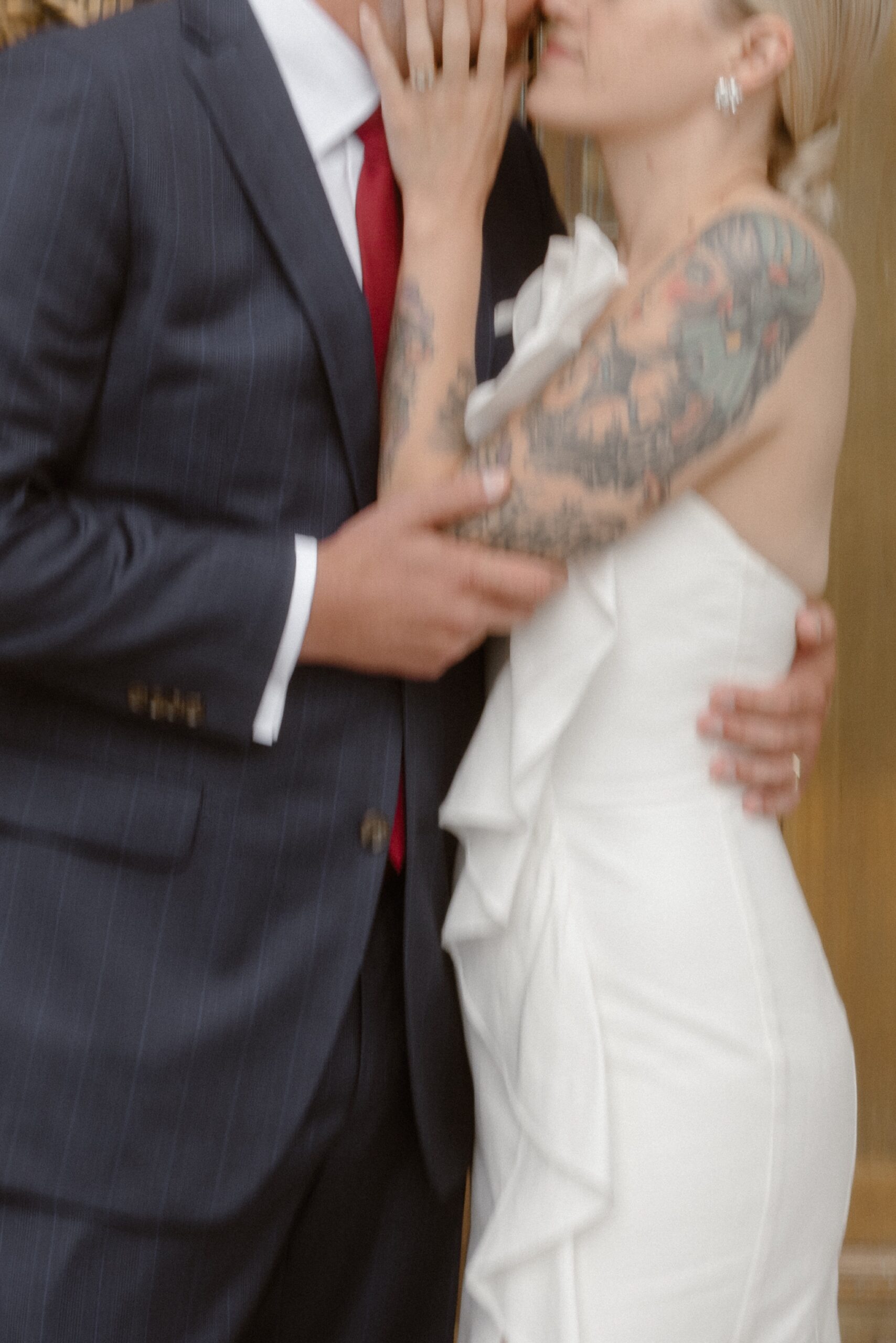 A blurry photo of a bride and groom posing together for their wedding portraits. Photo by Colorado wedding photographer Ashley Joyce.
