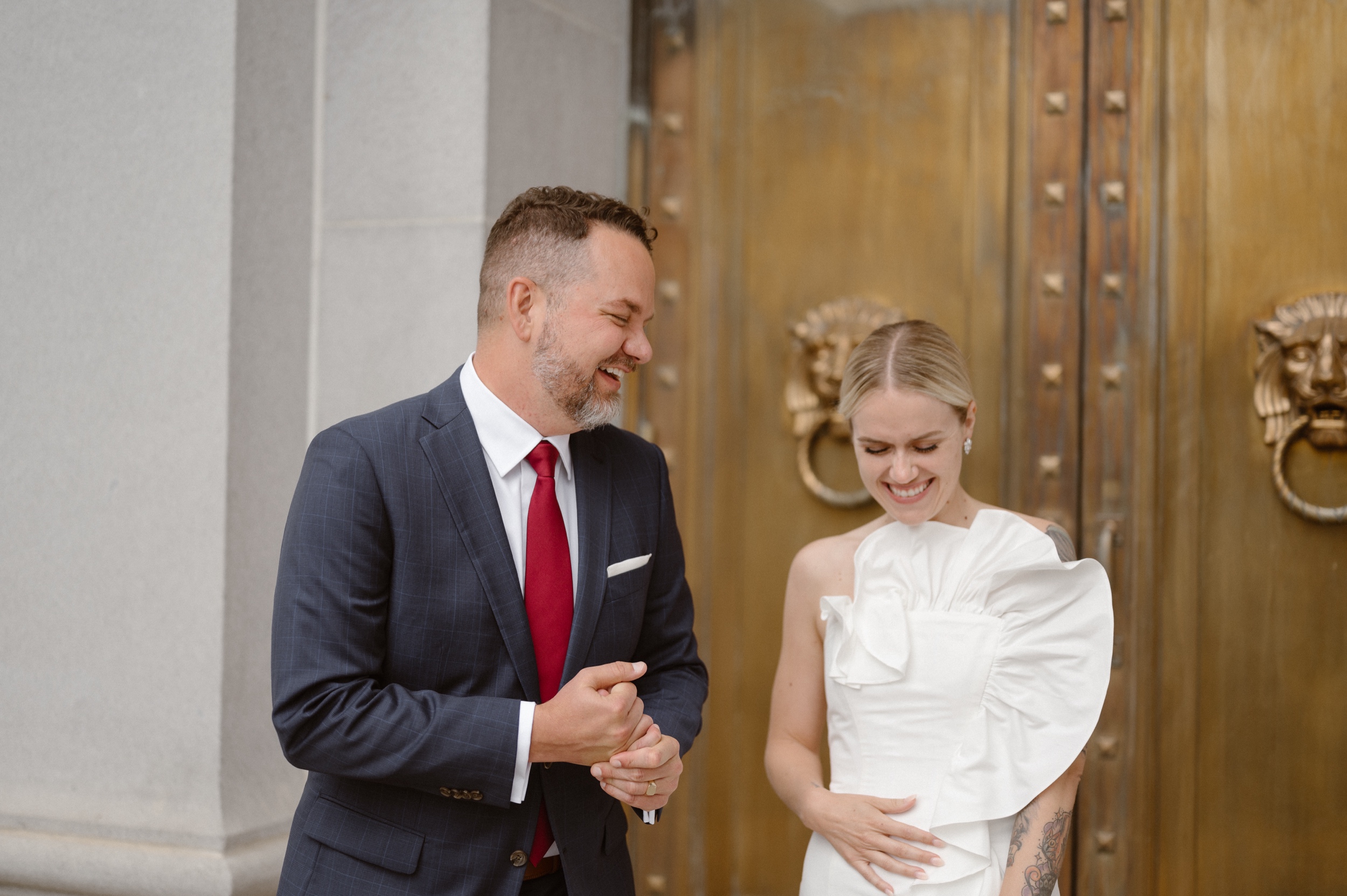 A candid wedding photo of a bride and groom laughing together. Photo by Colorado wedding photographer Ashley Joyce.