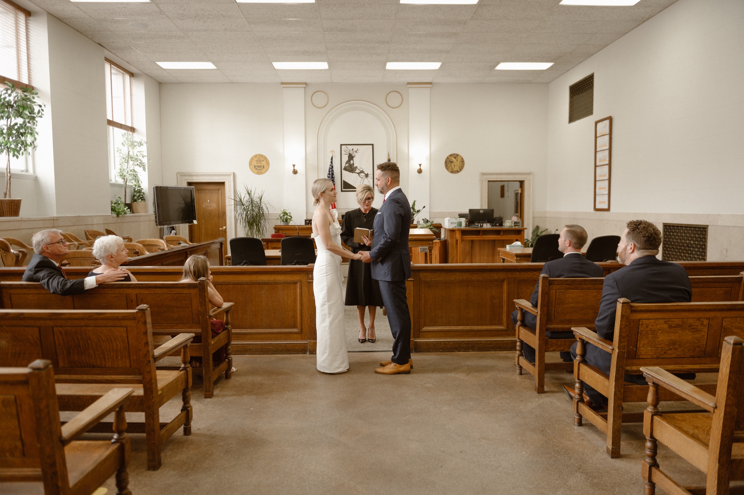 A photo of a bride and groom during their courthouse ceremony in Denver. Photo by Colorado wedding photographer Ashley Joyce.