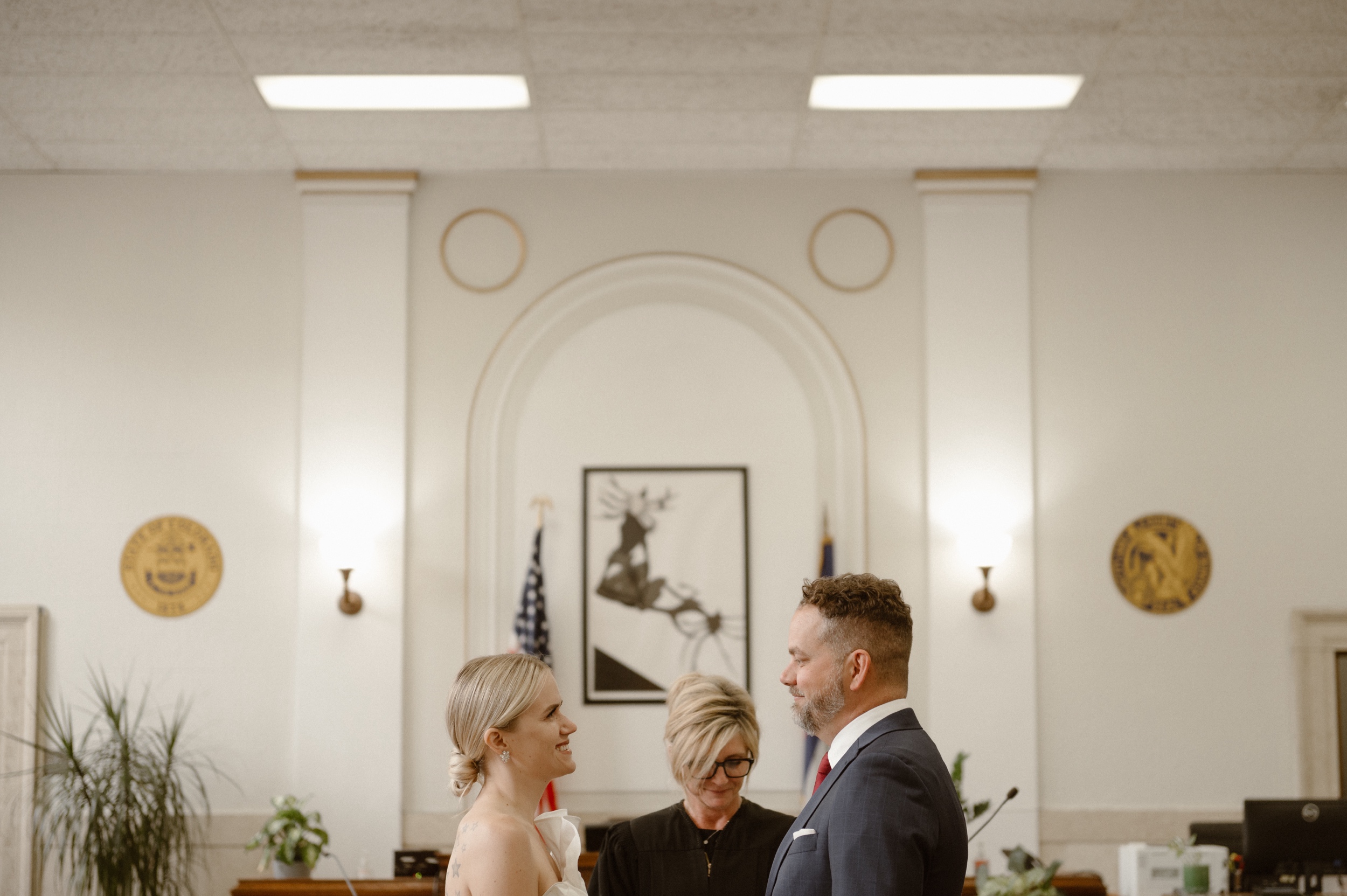 A photo of a bride and groom during their courthouse ceremony in Denver. Photo by Colorado wedding photographer Ashley Joyce.