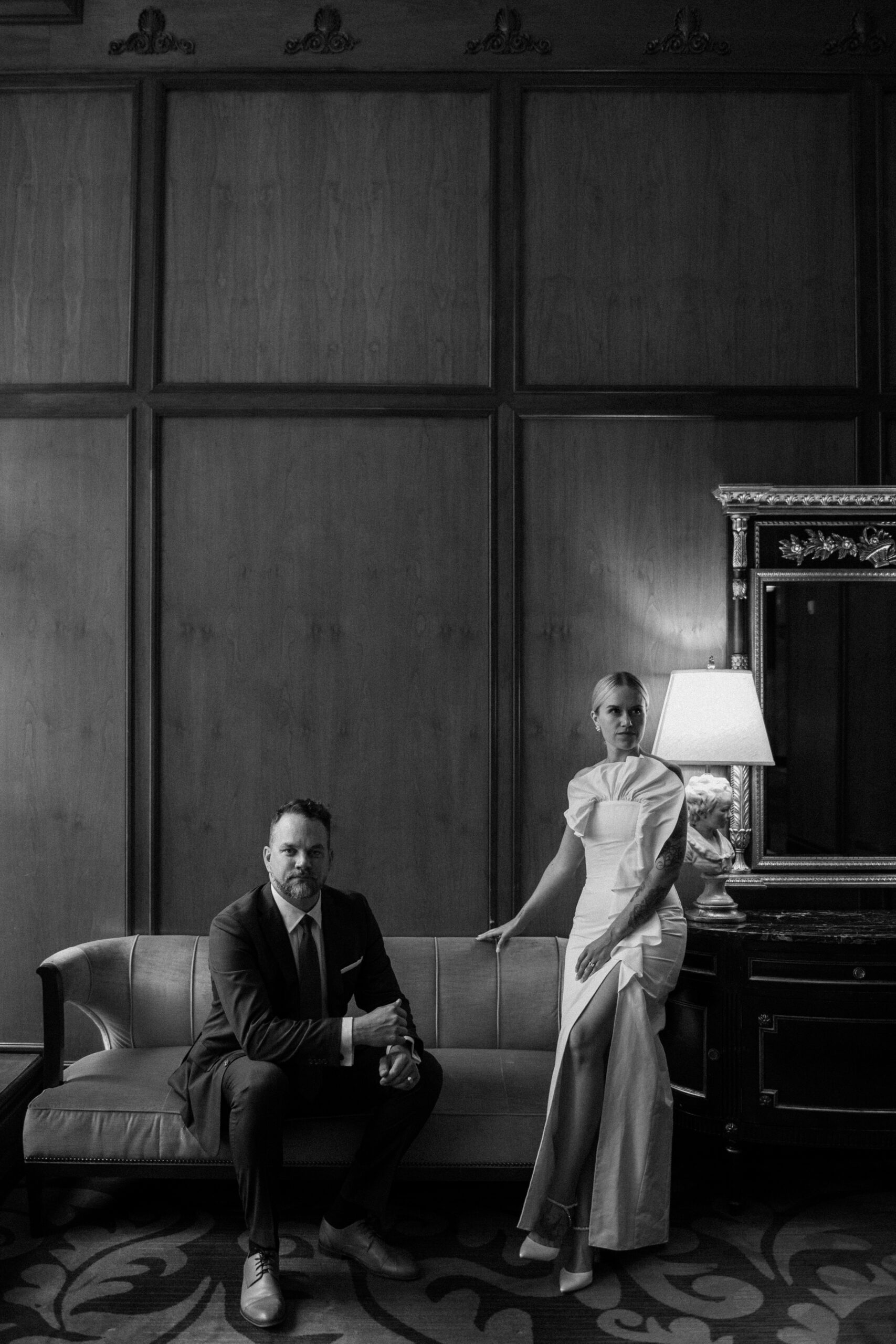 A bride and groom pose for their wedding portraits at the Brown Palace in Denver Colorado. Photo by Colorado wedding photographer Ashley Joyce.