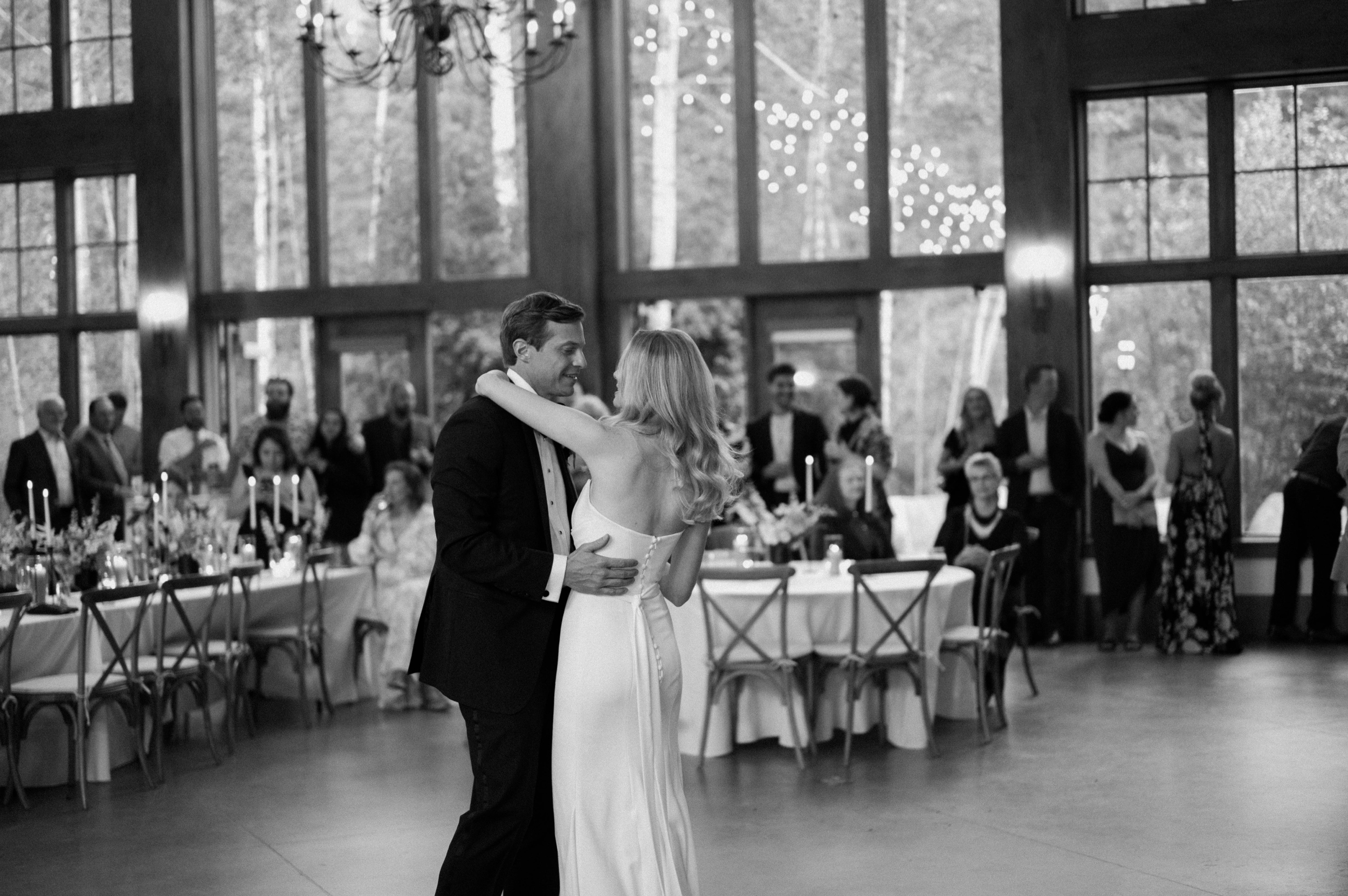 A bride and groom dance to their first dance at their wedding in Vail, Colorado. Photo by Colorado wedding photographer Ashley Joyce.