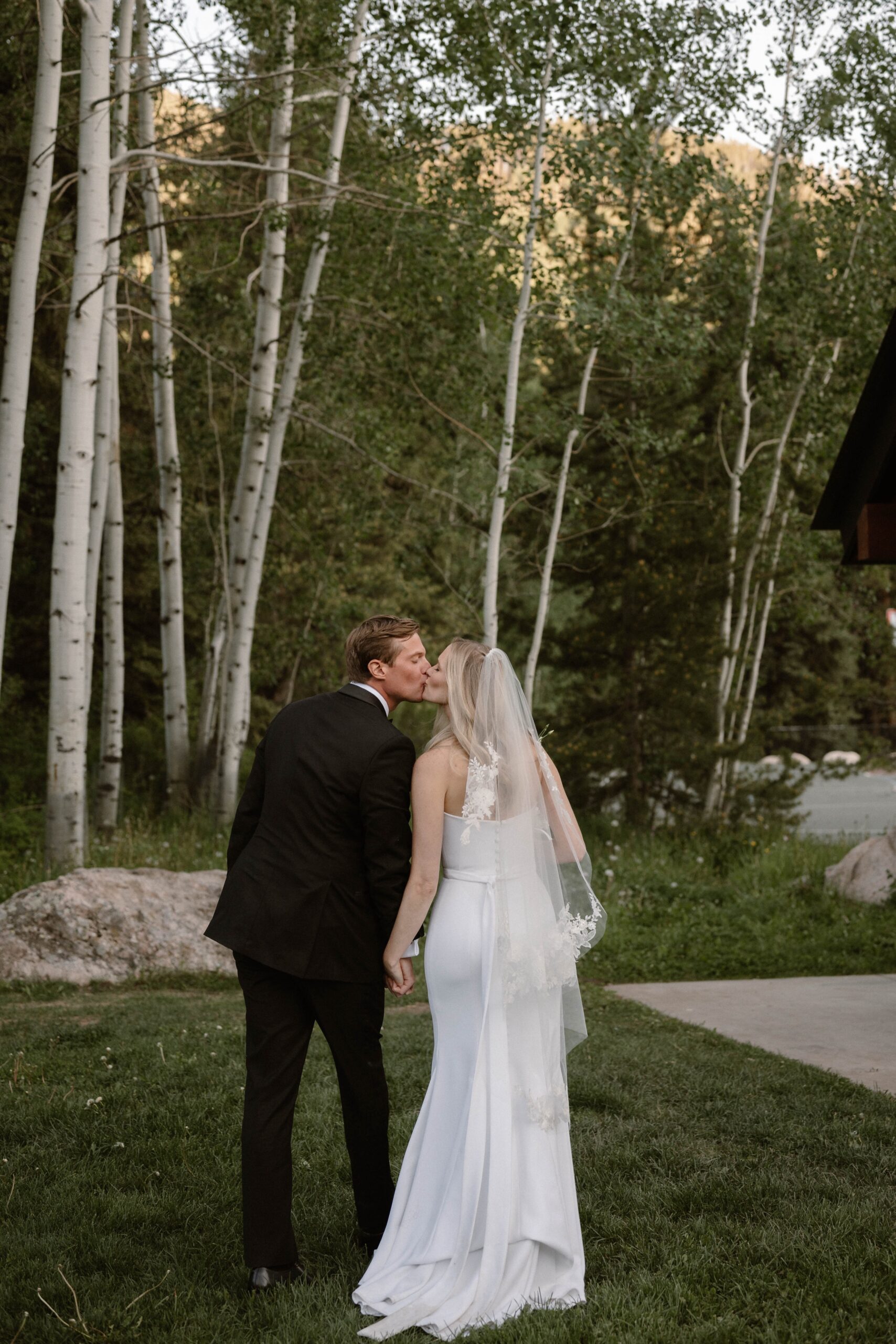 A couple posing for their wedding portraits for their Vail wedding at Donovan Pavilion. Photo by Colorado wedding photographer Ashley Joyce