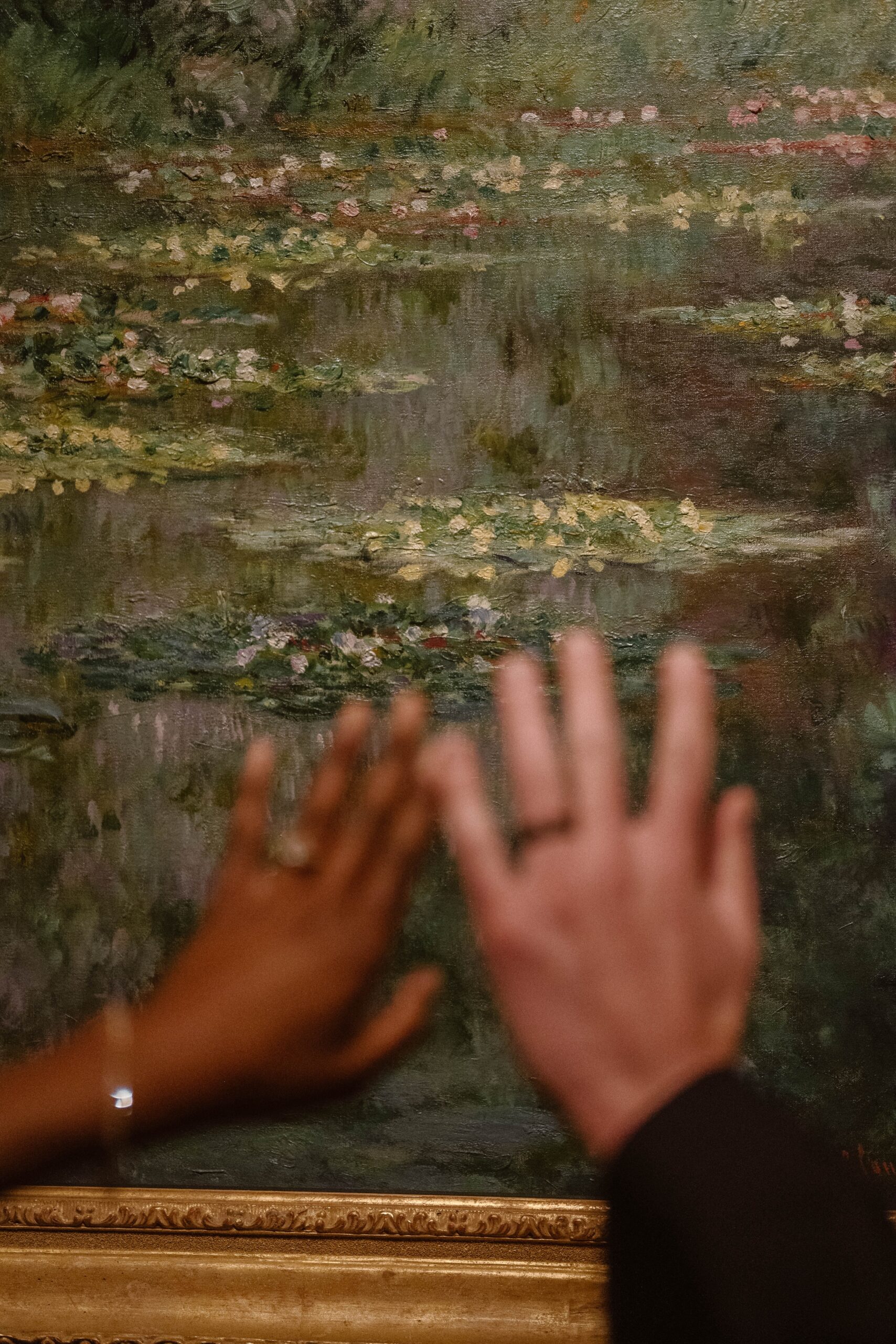 Wedding portrait of a bride and grooms hand in front of a painting at the Denver Art Museum. Photo by Durango and Telluride wedding photographer Ashley Joyce.