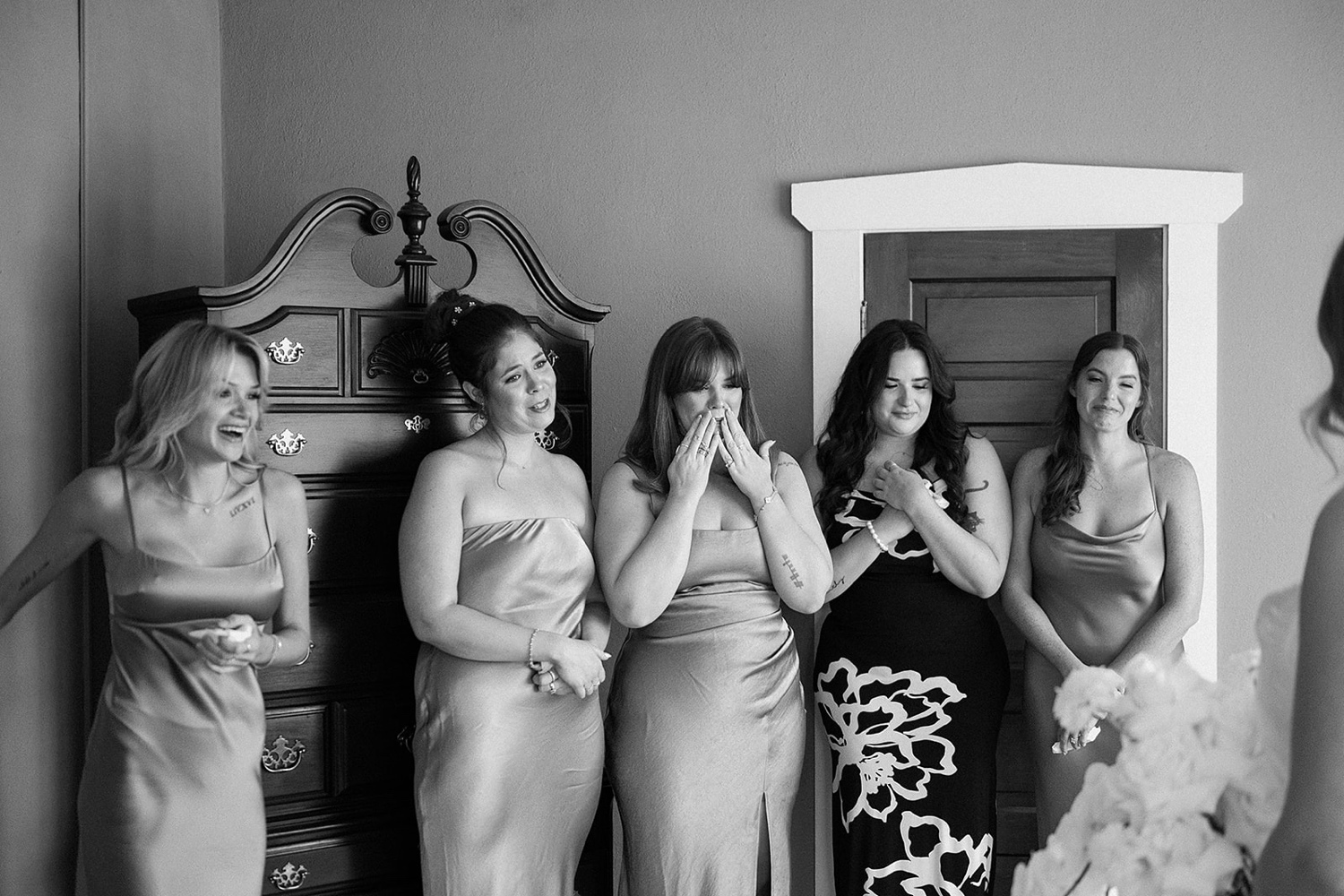 Bridesmaids looking lovingly at the bride when they see her for the first time