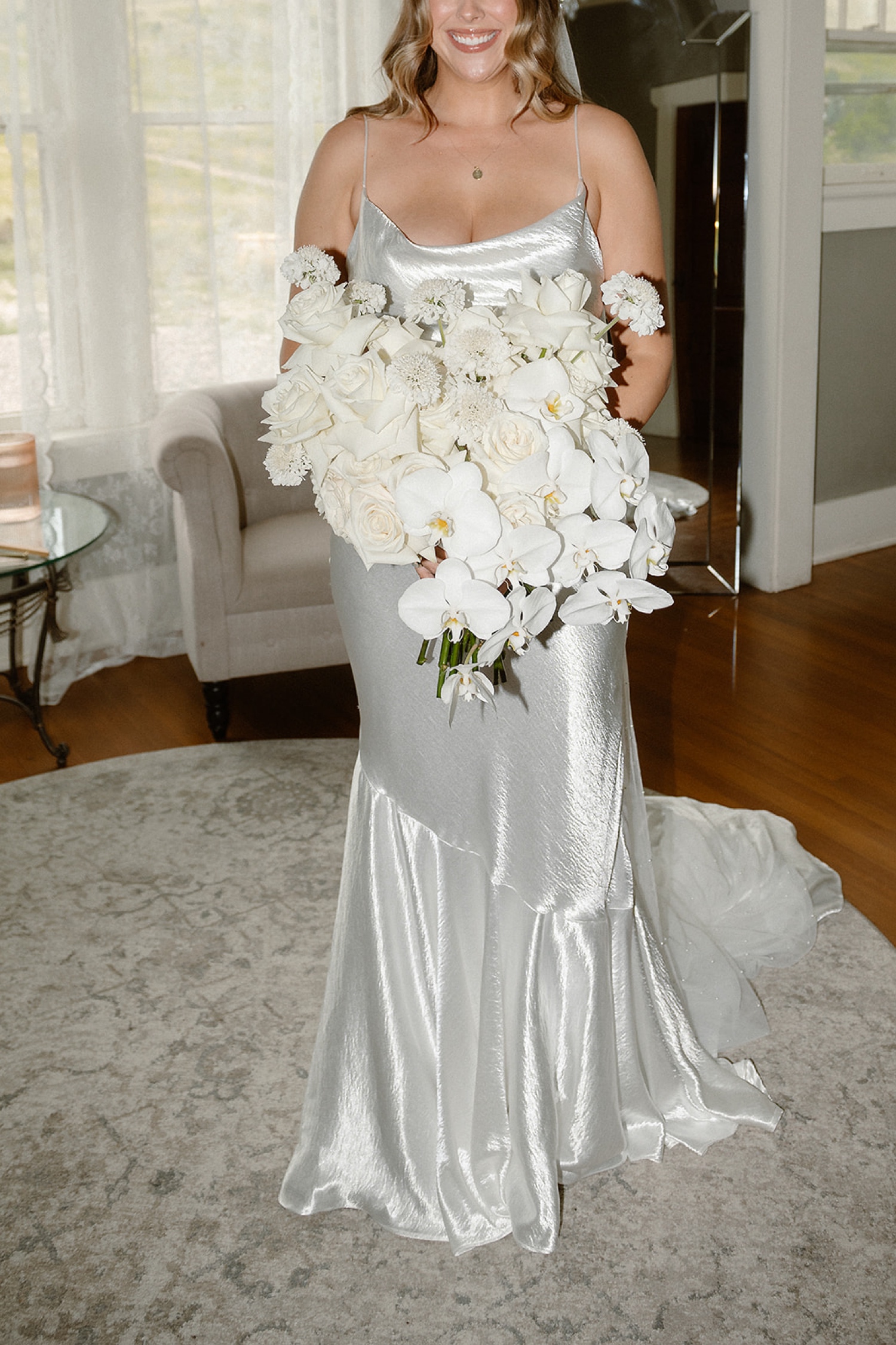 A bride posing with her wedding bouquet