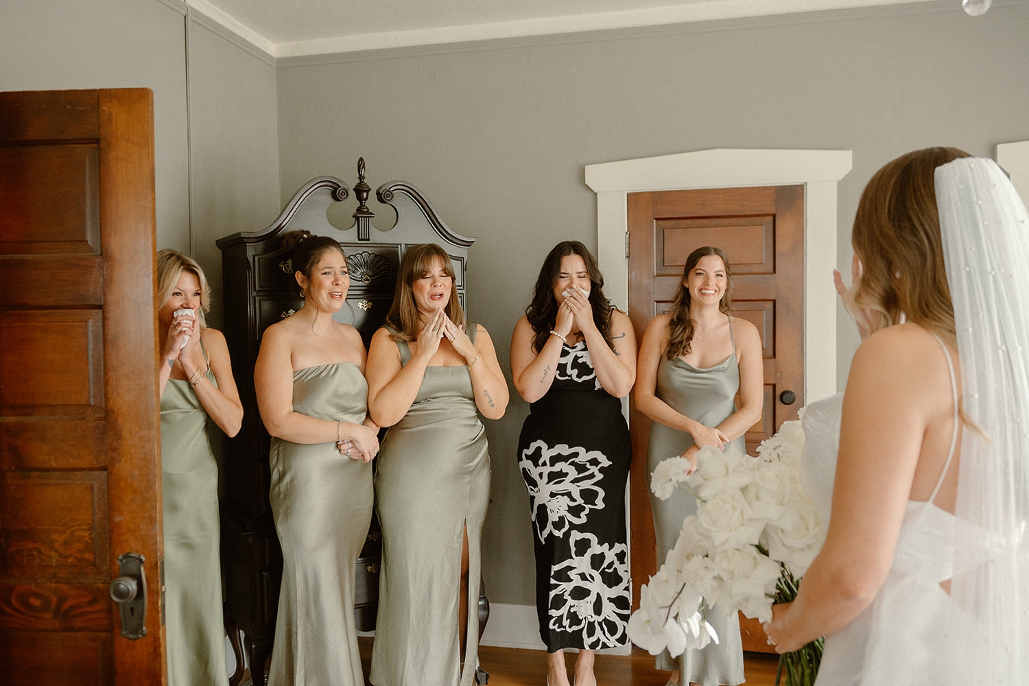 Bridesmaids looking lovingly at the bride when they see her for the first time