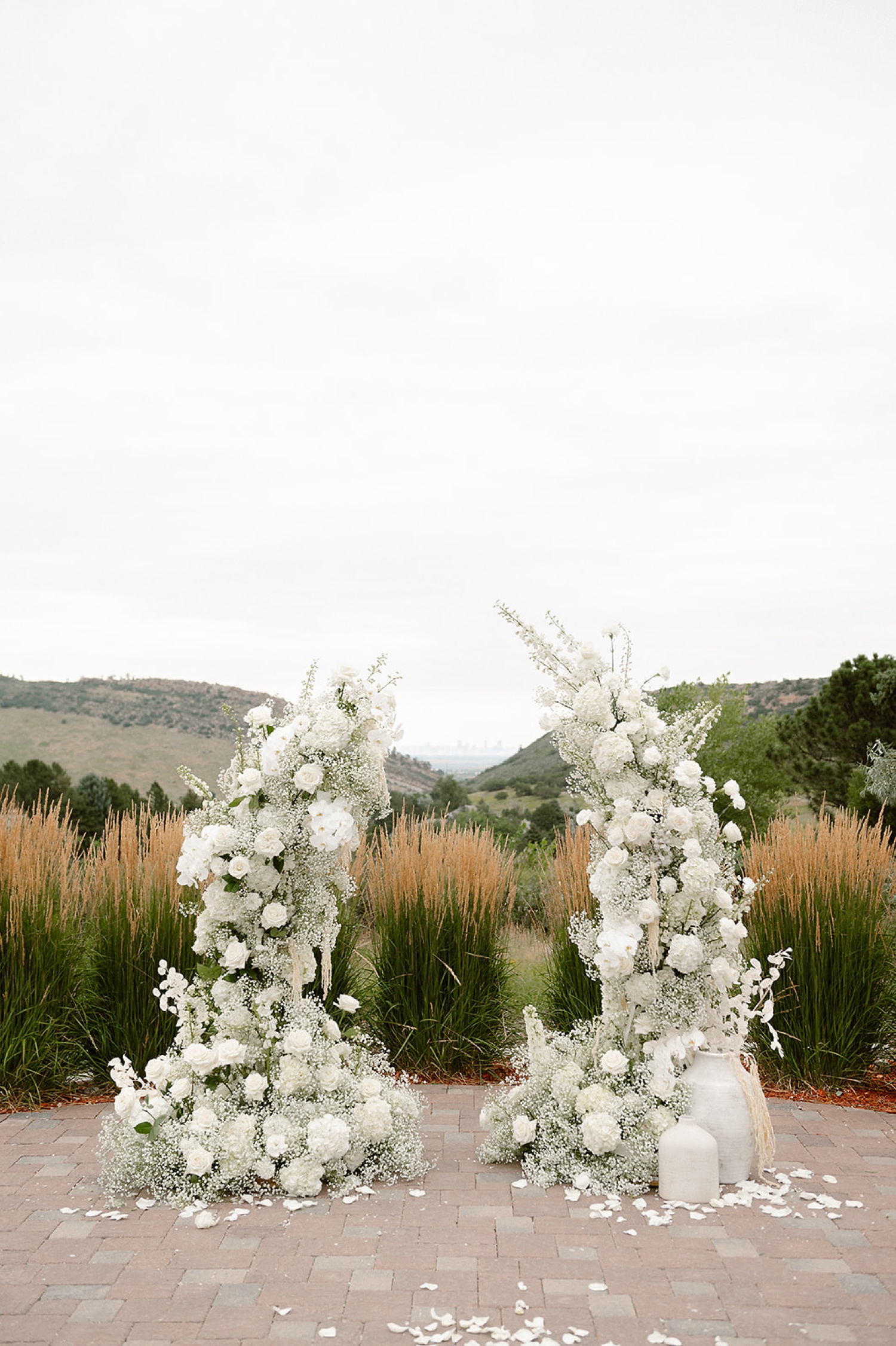 An all-white floral wedding arch at The Manor House