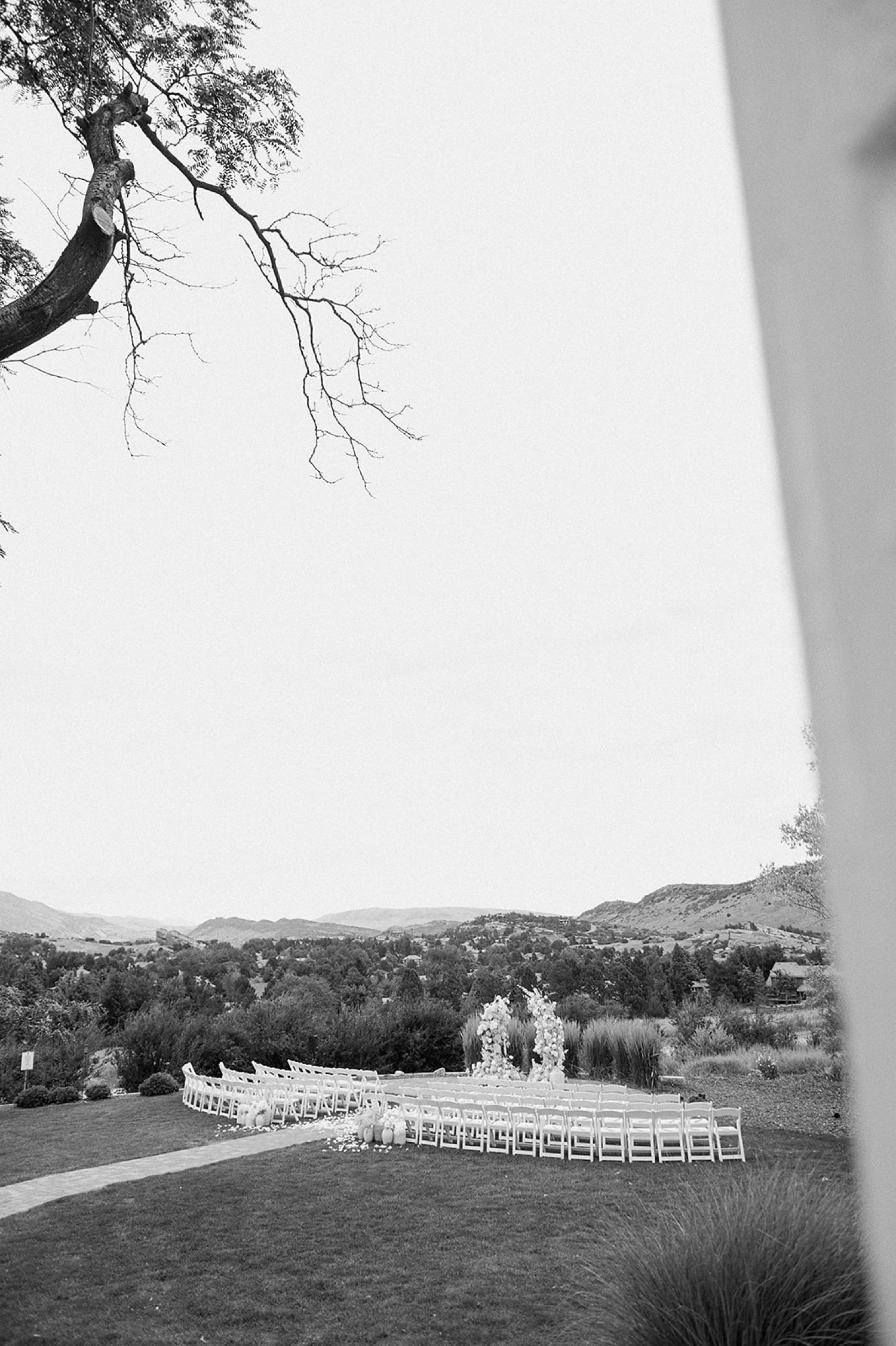 A black and white photo of an empty wedding ceremony site at The Manor House