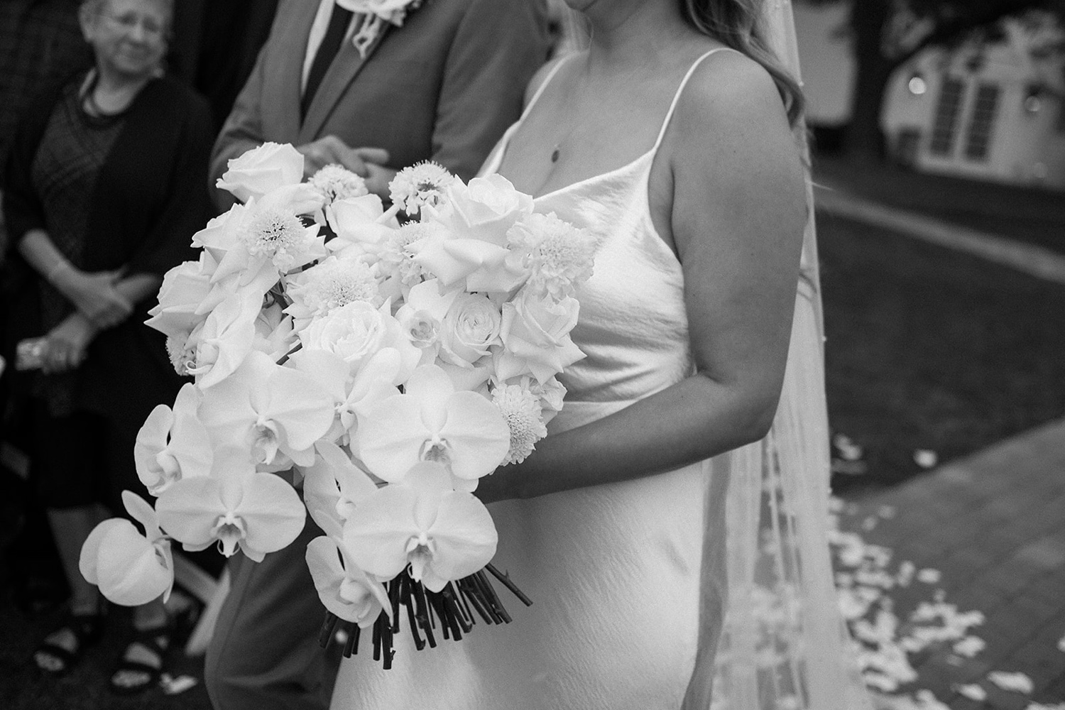 A bride holding her wedding bouquet as she walks down the aisle