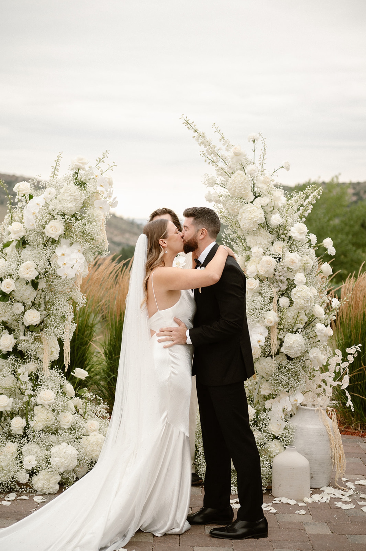 A bride and groom kiss at their wedding ceremony at The Manor House