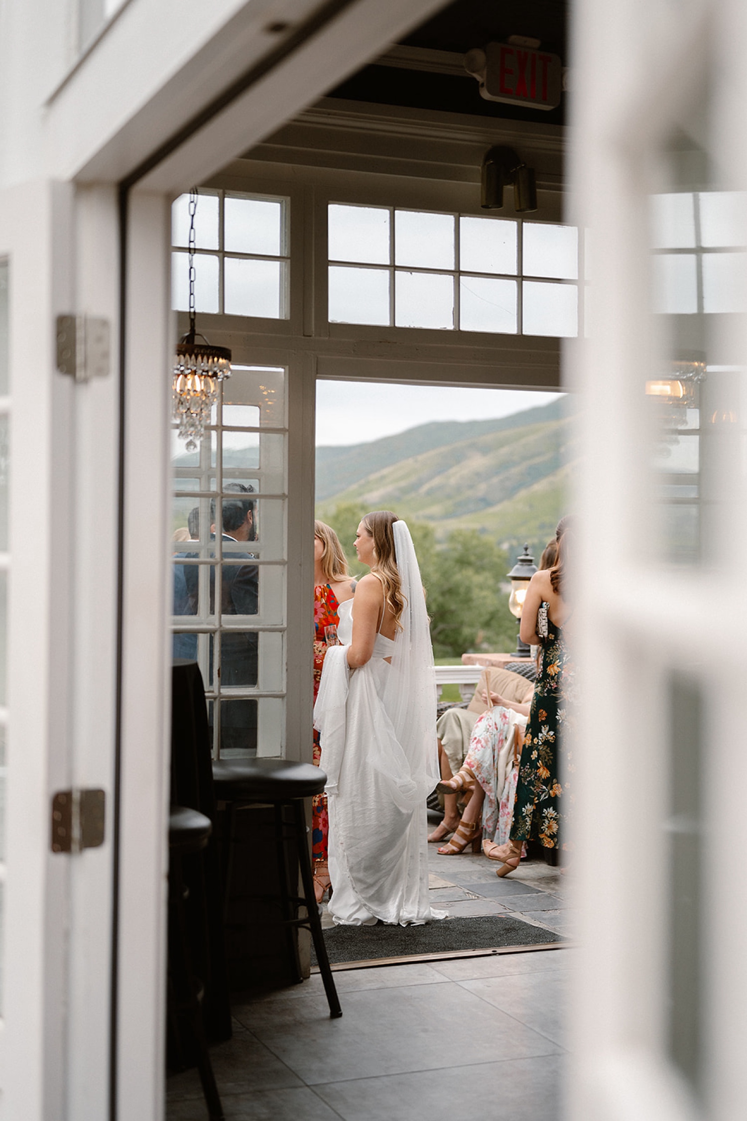 A bride stands with wedding guests at The Manor House