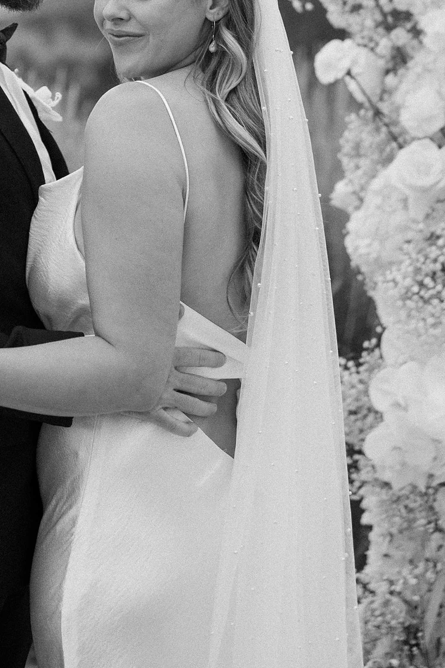 A bride and groom embrace for their wedding portraits at The Manor House