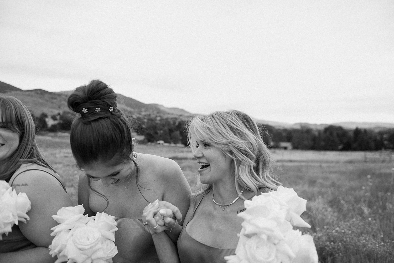 Bridesmaids laugh and walk past the camera