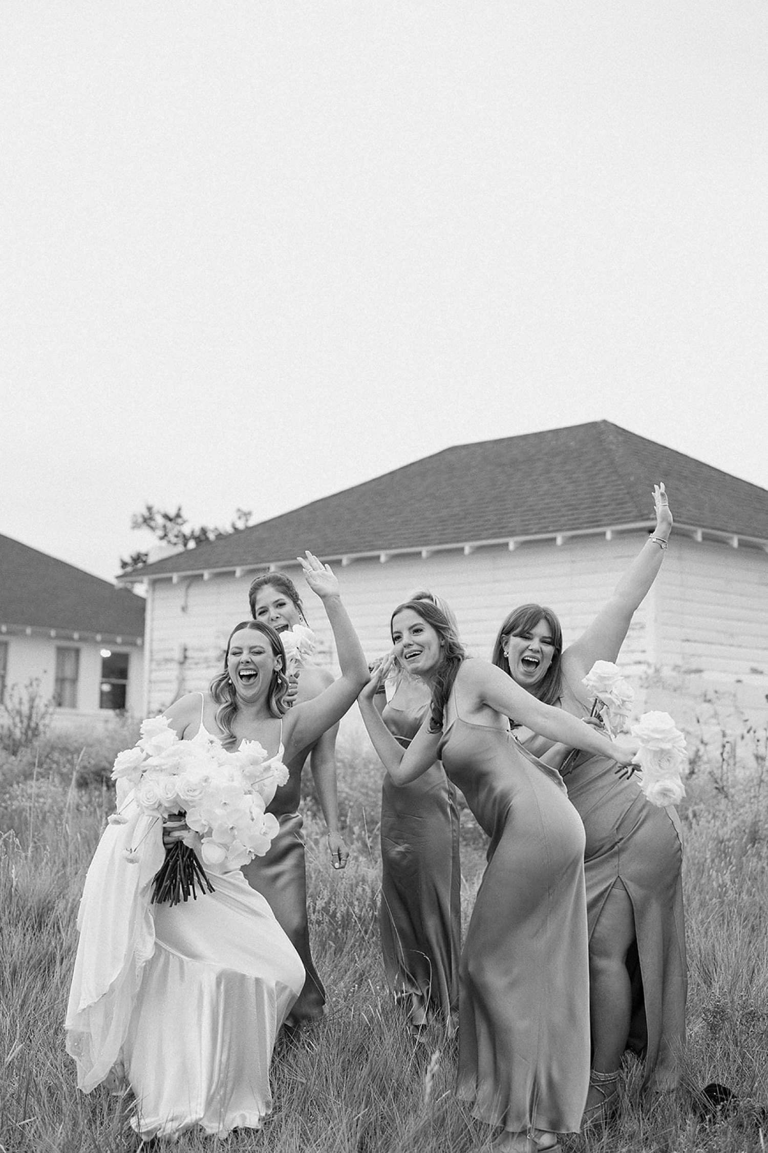 A bride and her bridesmaids cheer together