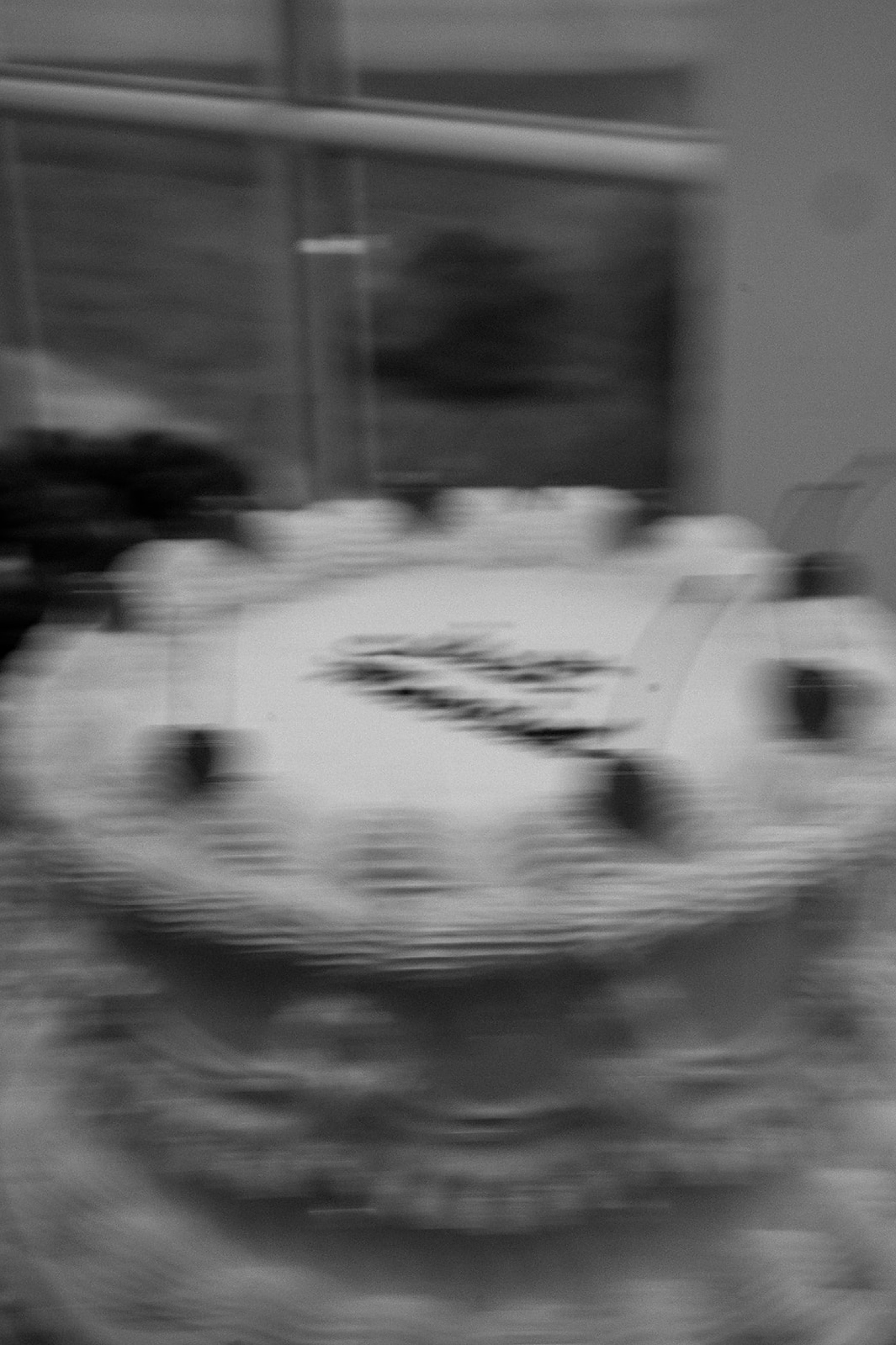 A blurry photo of a vintage wedding cake topped with cherries