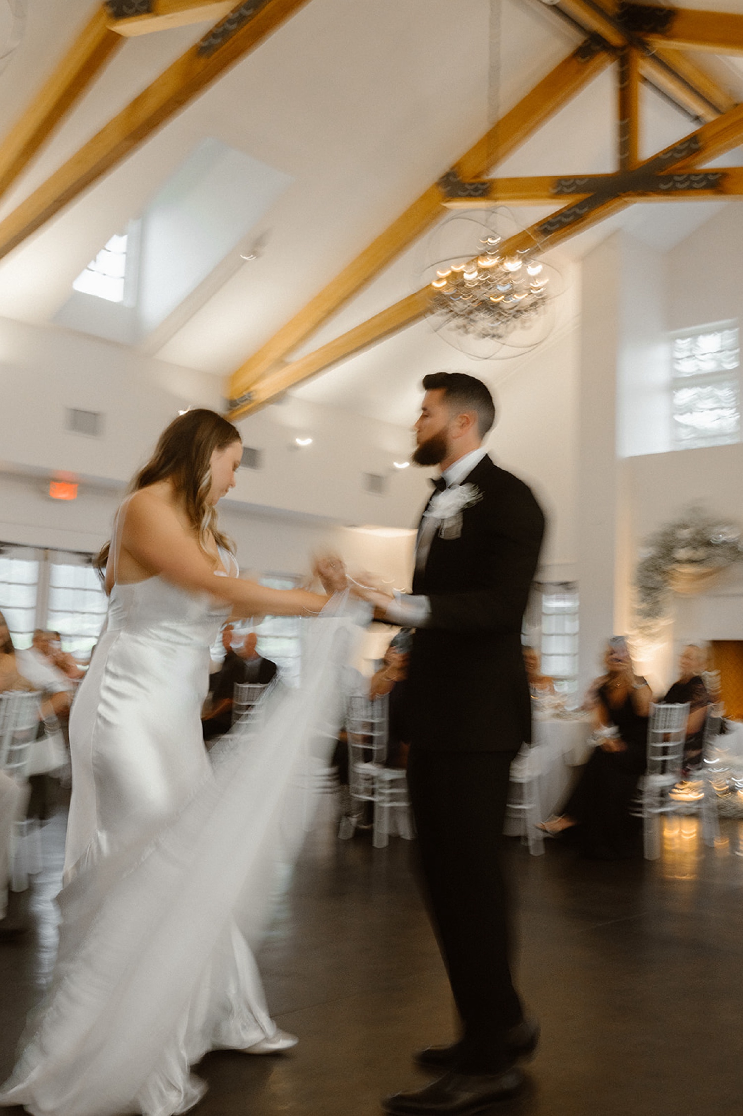 A blurry photo of a bride and groom dancing their first dance at their wedding