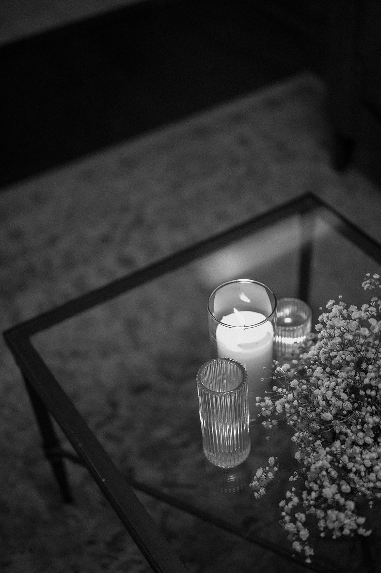 Candles and flowers sit on a table at the wedding reception