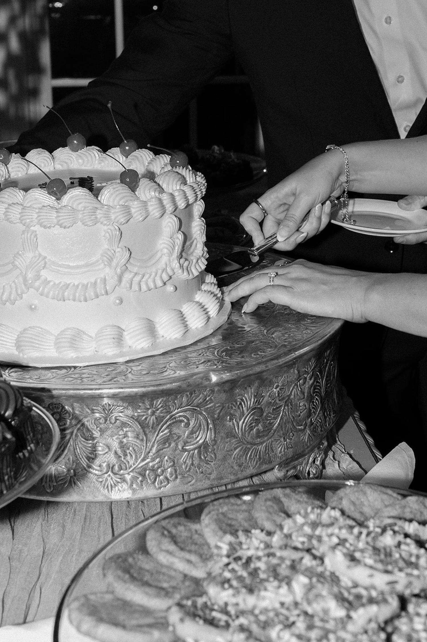 A bride and groom cut their vintage wedding cake