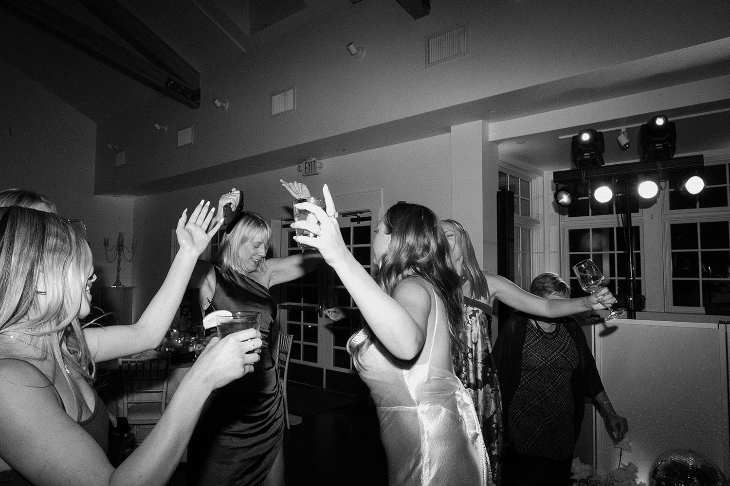 Wedding guests dance with the bride on the dance floor