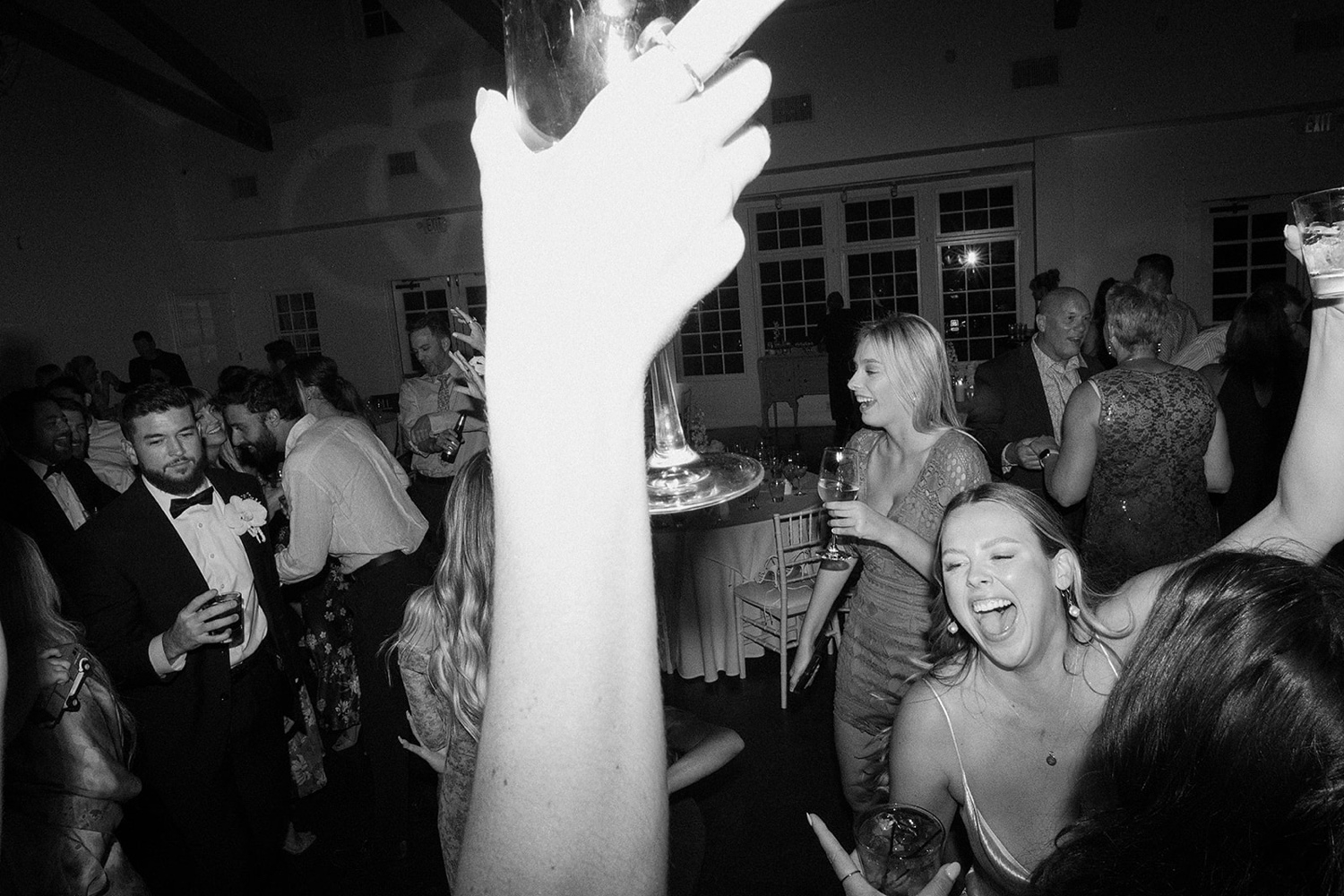 Wedding guests dance with the bride on the dance floor