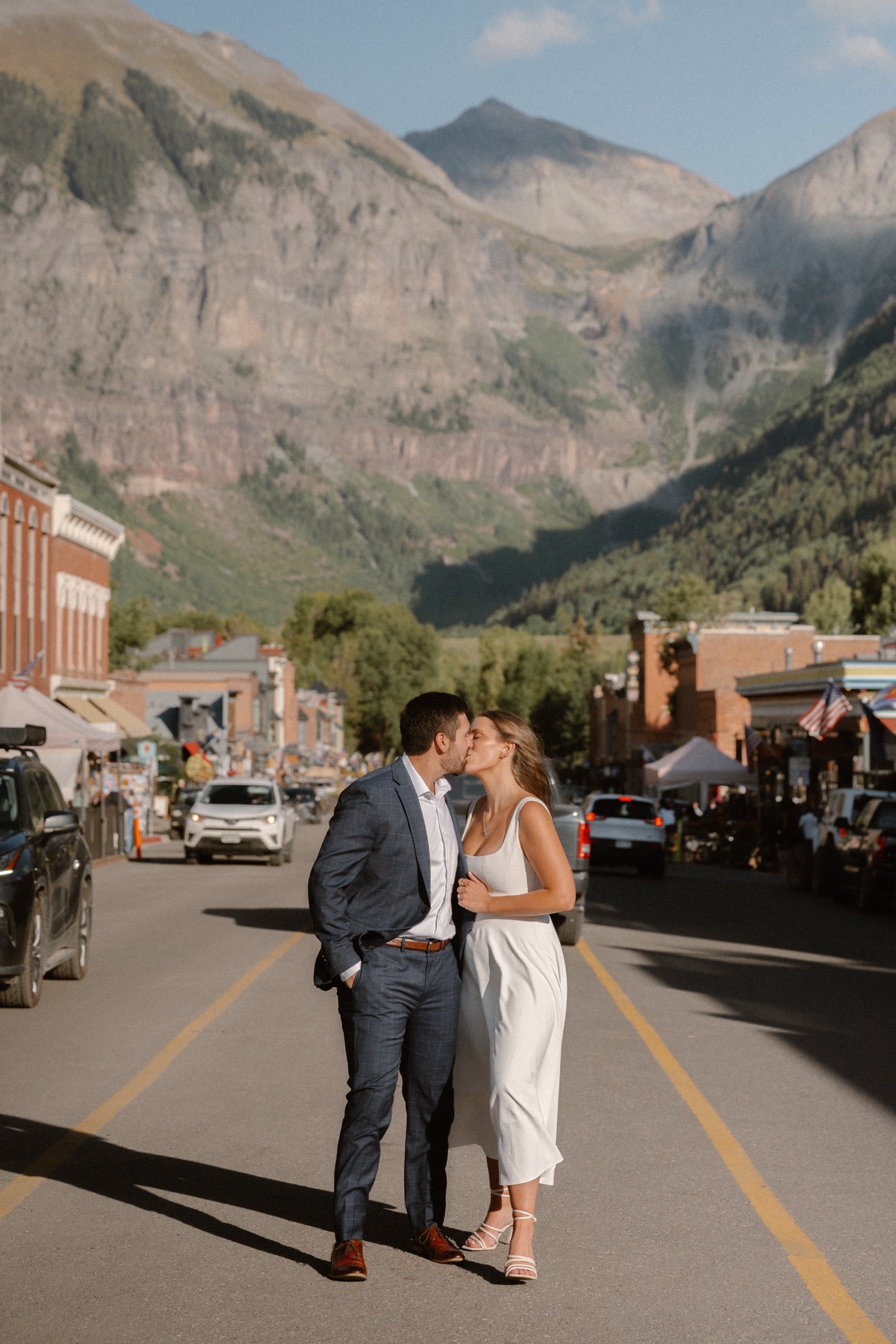 A couple poses for their Telluride engagement session in downtown Telluride, Colorado. Photo by Durango wedding photographer Ashley Joyce