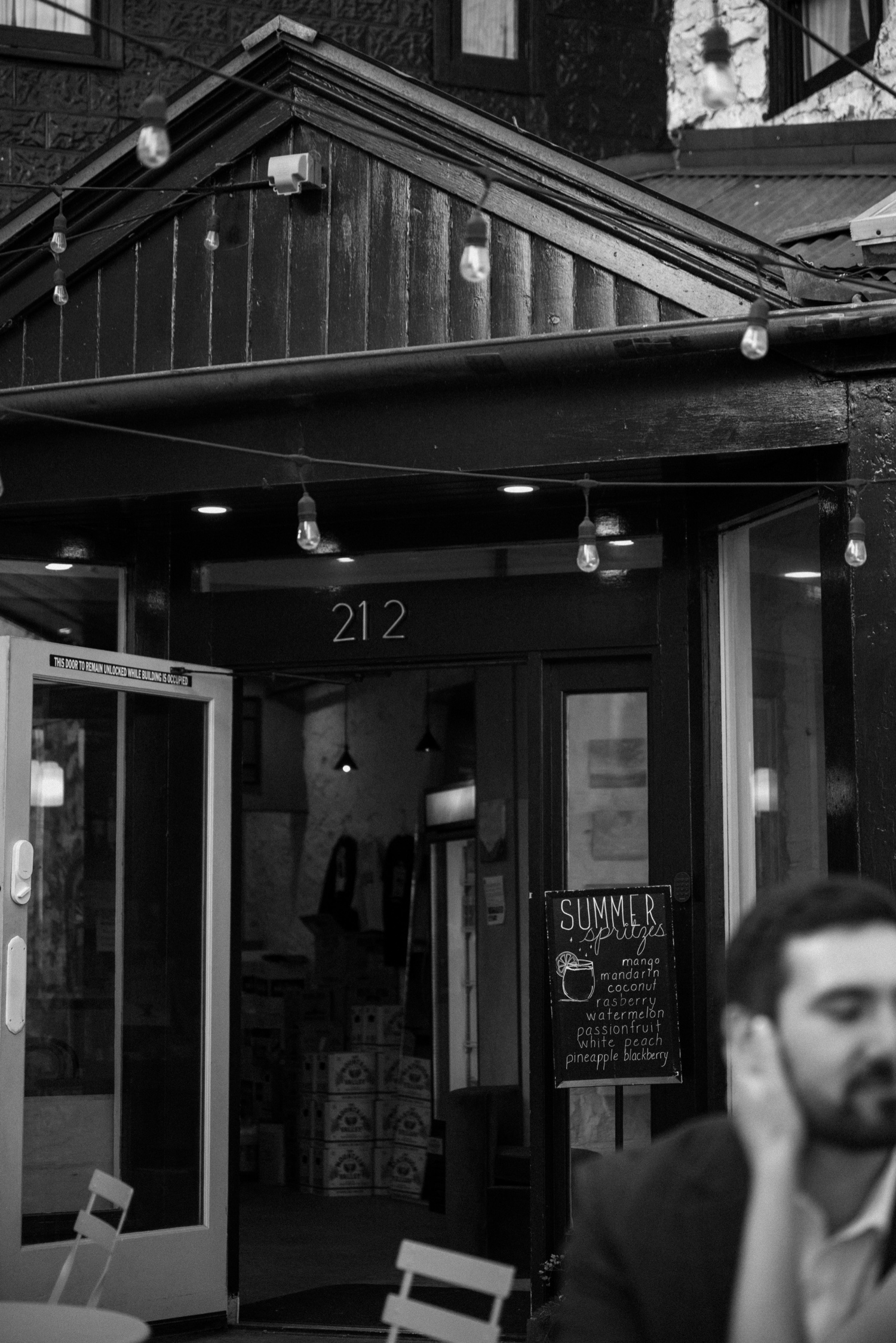 A couple poses for their Telluride engagement session in downtown Telluride, Colorado. Photo by Durango wedding photographer Ashley Joyce