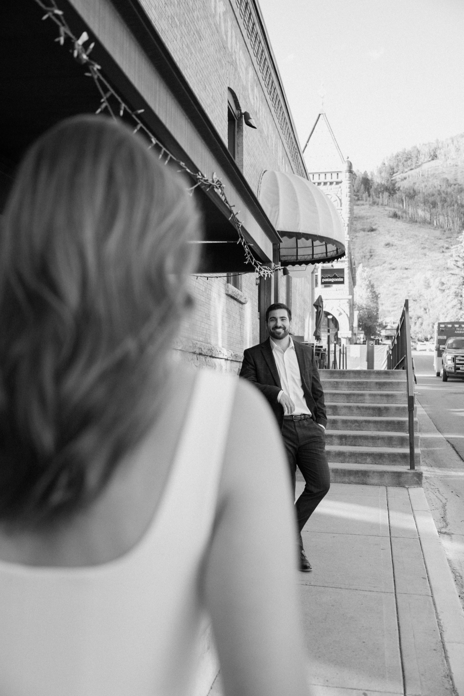 A couple poses for their Telluride engagement session in downtown Telluride, Colorado. Photo by Durango wedding photographer Ashley Joyce