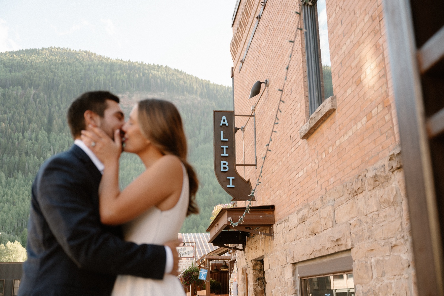 A couple poses for their Telluride engagement session in downtown Telluride, Colorado. Photo by Durango wedding photographer Ashley Joyce