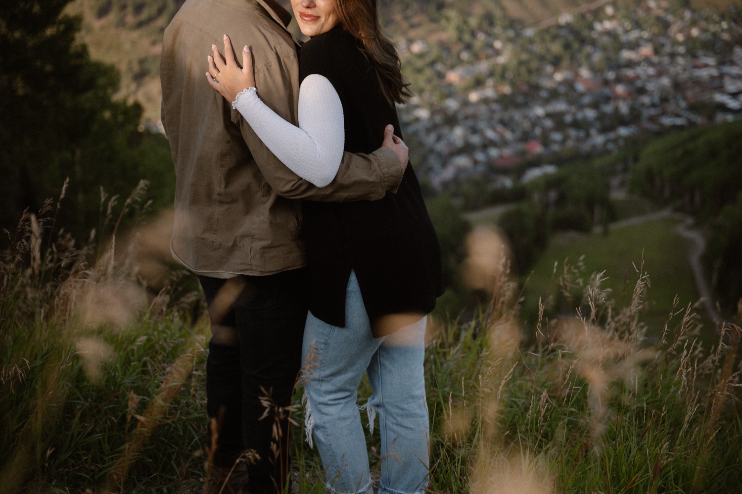 A couple poses for their Telluride engagement session at San Sophia Overlook at the Telluride ski resort. Photo by Durango wedding photographer Ashley Joyce