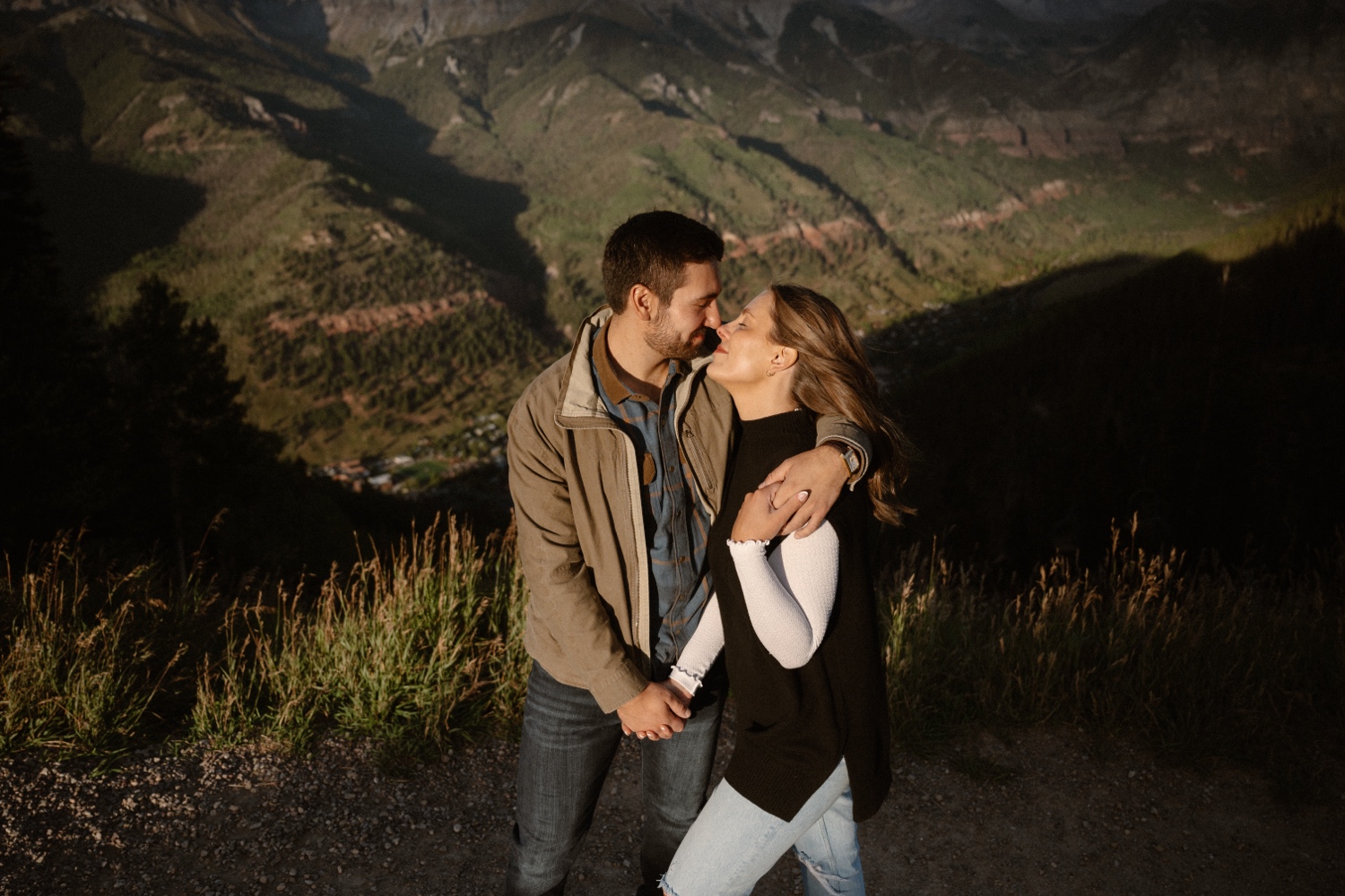 A couple poses for their Telluride engagement session at San Sophia Overlook at the Telluride ski resort. Photo by Durango wedding photographer Ashley Joyce