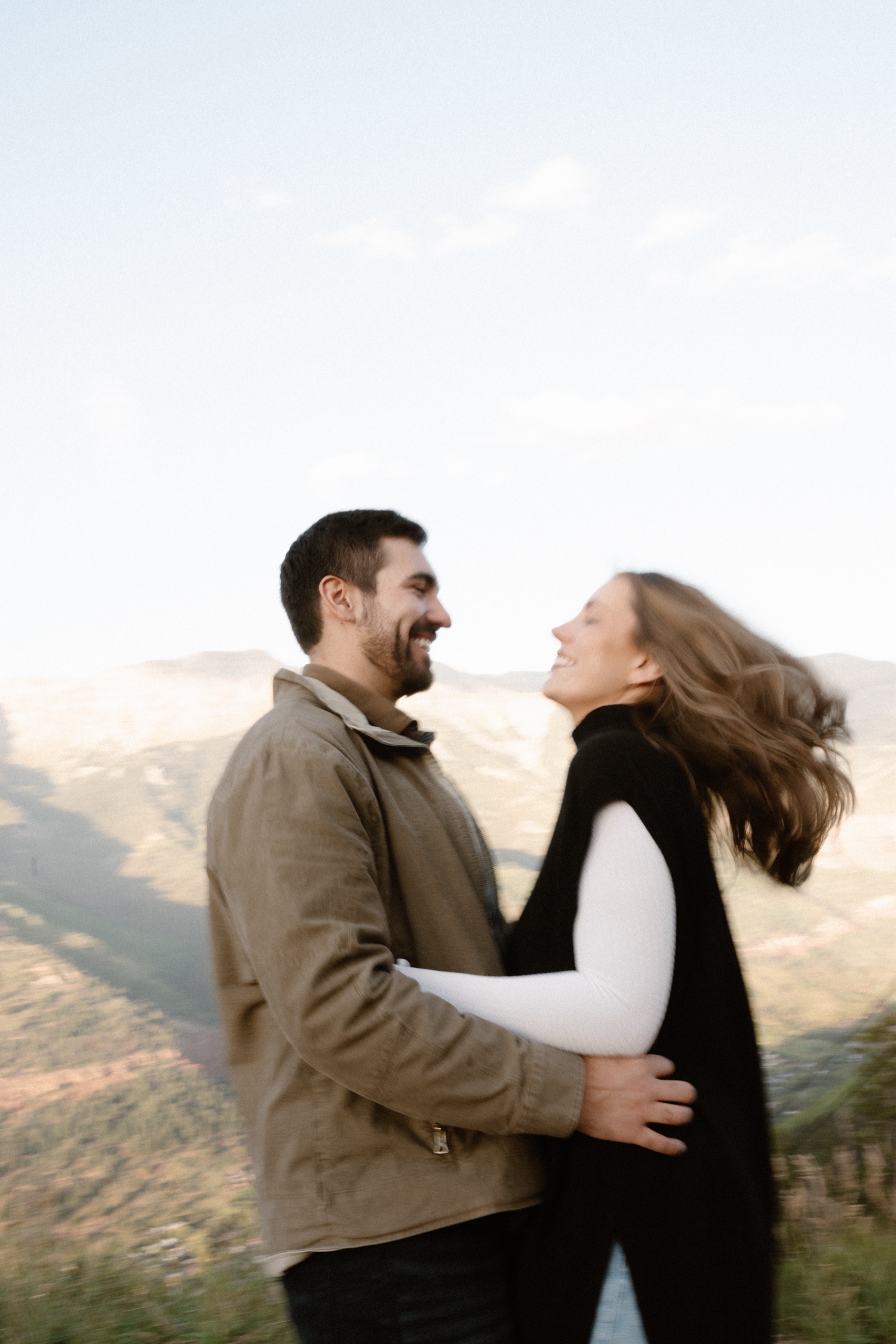 A couple poses for their Telluride engagement session at San Sophia Overlook at the Telluride ski resort. Photo by Durango wedding photographer Ashley Joyce