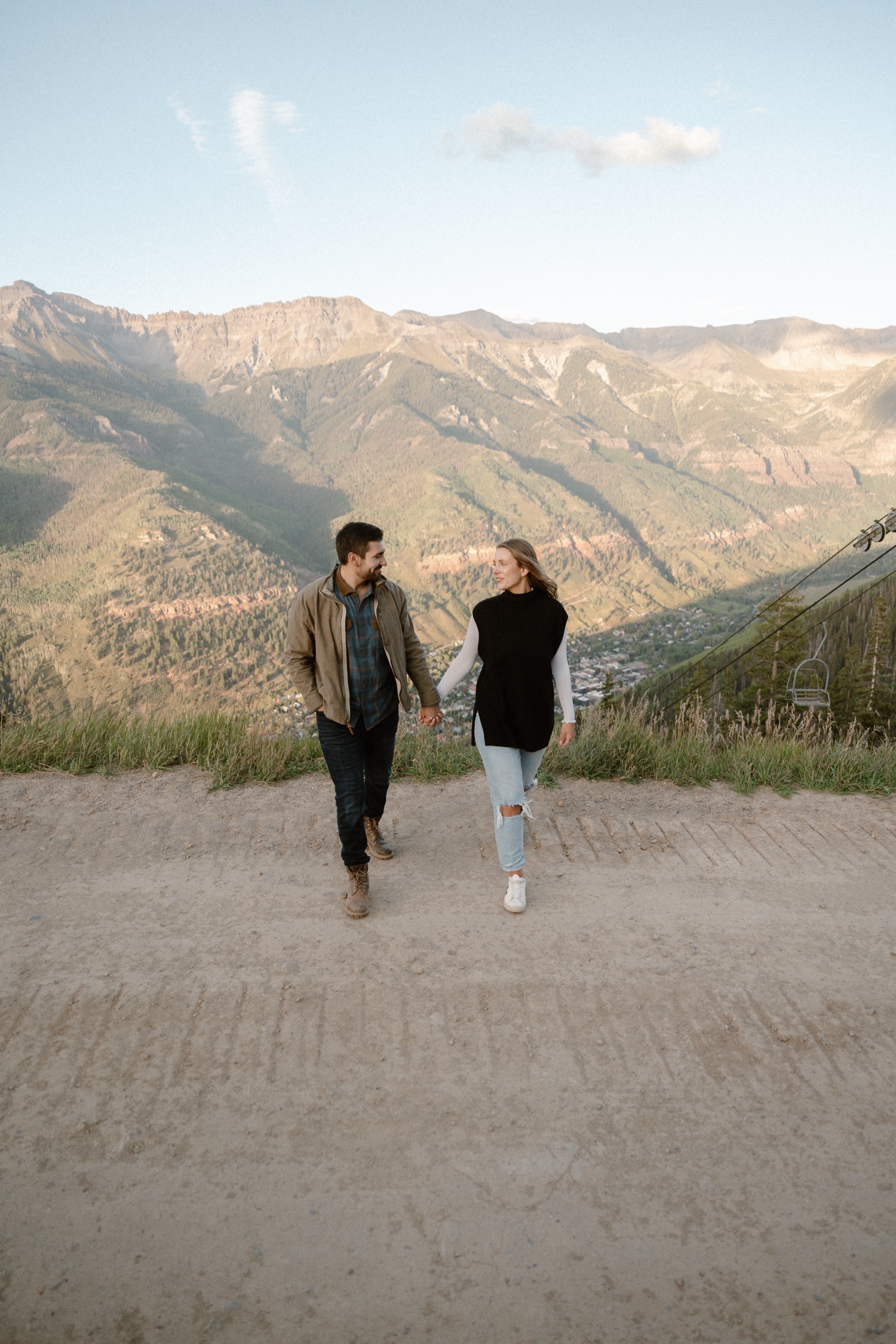 A couple poses for their Telluride engagement session at San Sophia Overlook at the Telluride ski resort. Photo by Durango wedding photographer Ashley Joyce