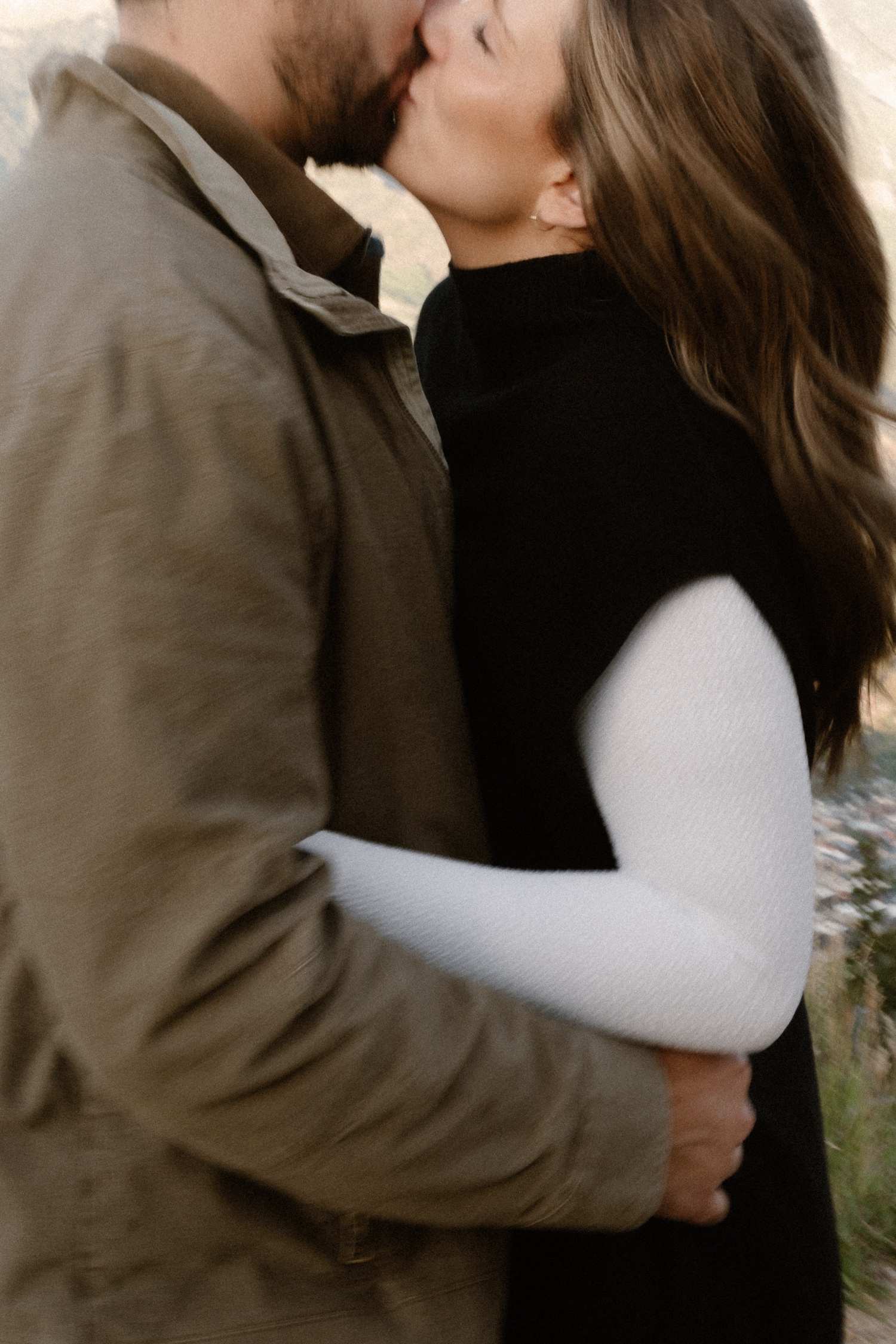 A couple poses for their Telluride engagement session at San Sophia Overlook at the Telluride ski resort. Photo by Durango wedding photographer Ashley Joyce