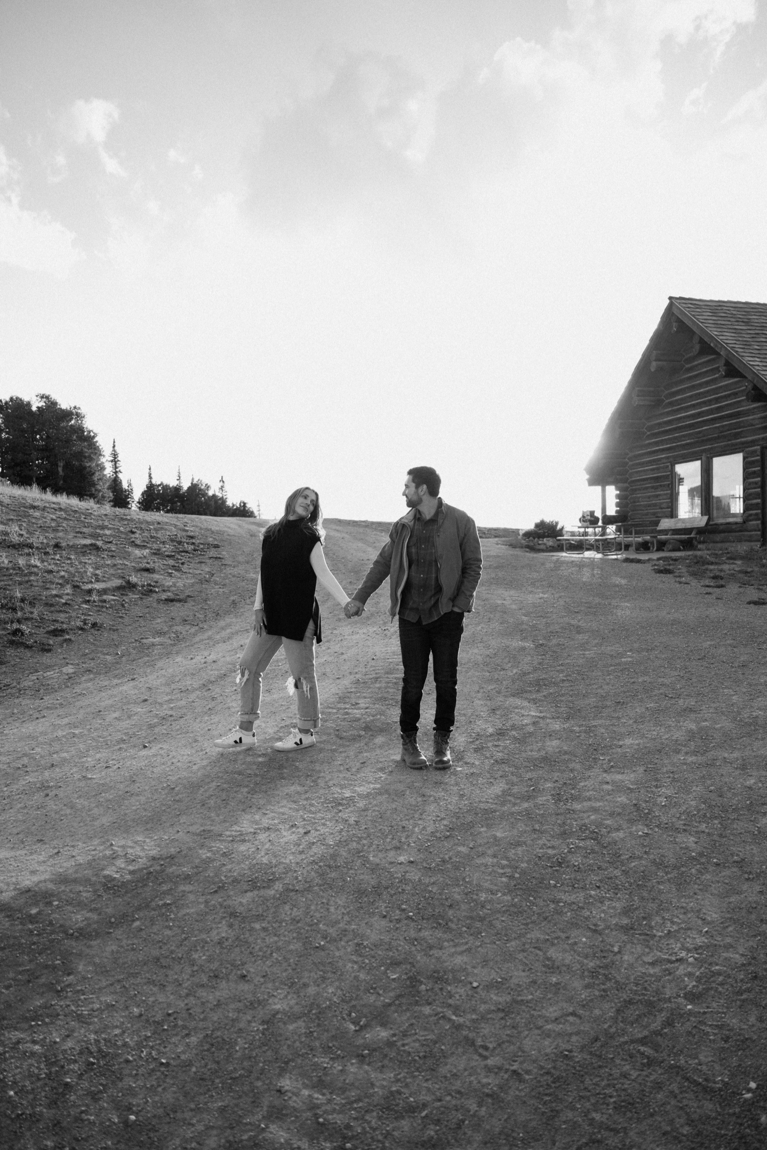 A couple poses for their Telluride engagement session at San Sophia Overlook at the Telluride ski resort. Photo by Durango wedding photographer Ashley Joyce