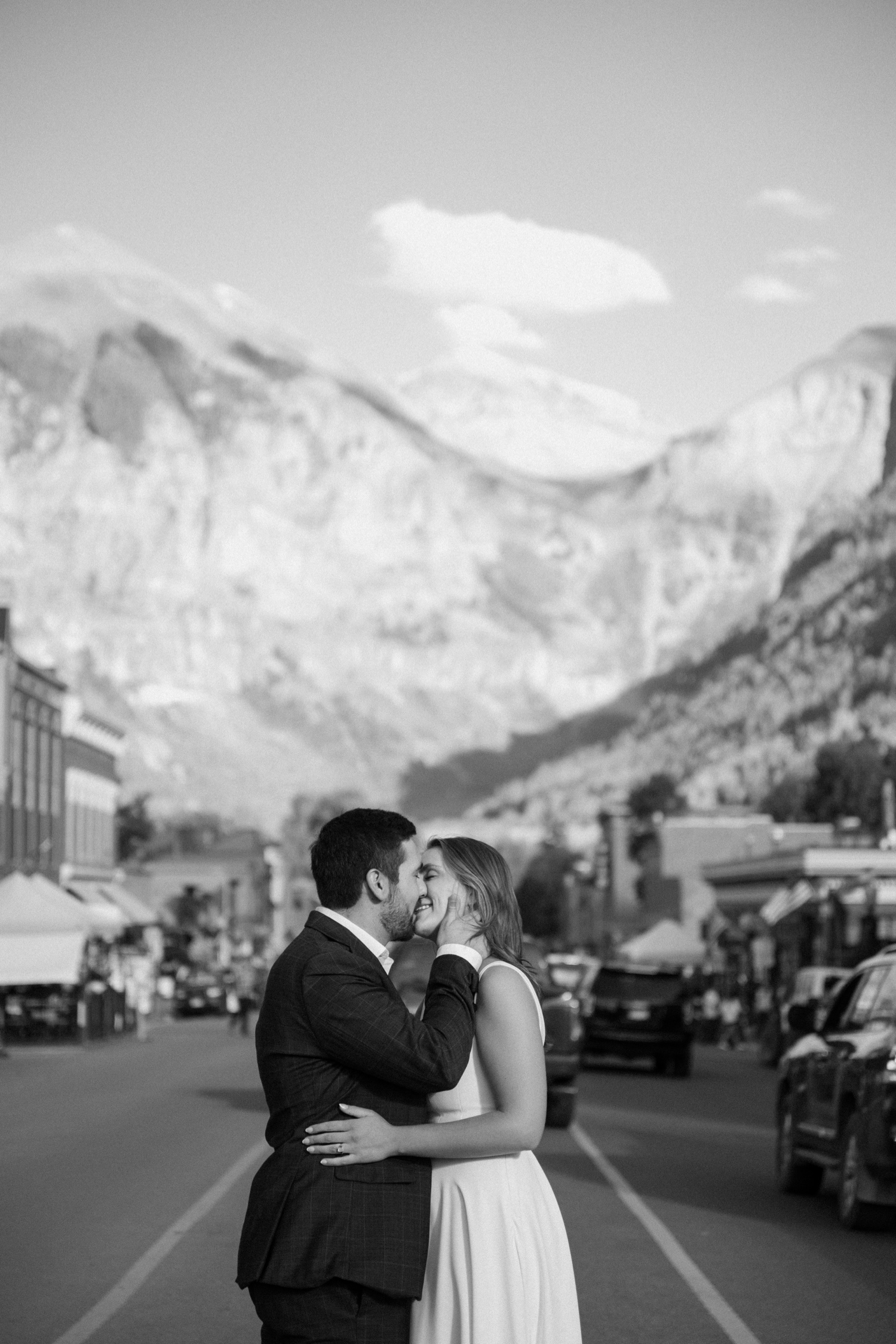 A couple poses for their Telluride engagement session in downtown Telluride, Colorado. Photo by Durango wedding photographer Ashley Joyce