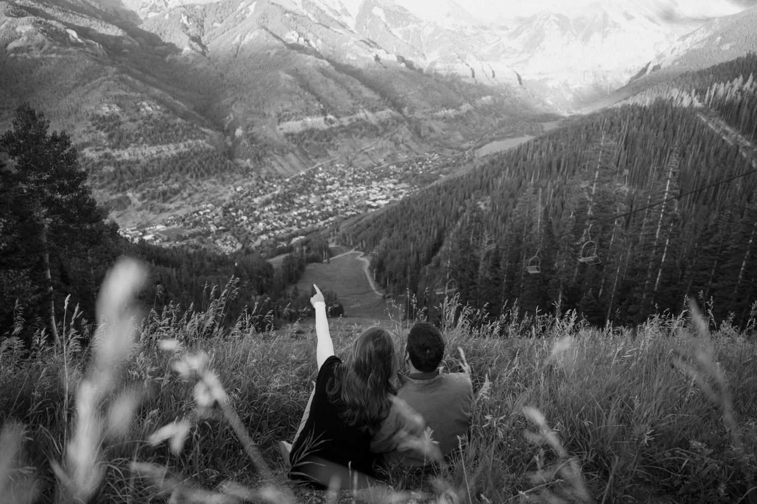 A couple poses for their Telluride engagement session at San Sophia Overlook at the Telluride ski resort. Photo by Durango wedding photographer Ashley Joyce