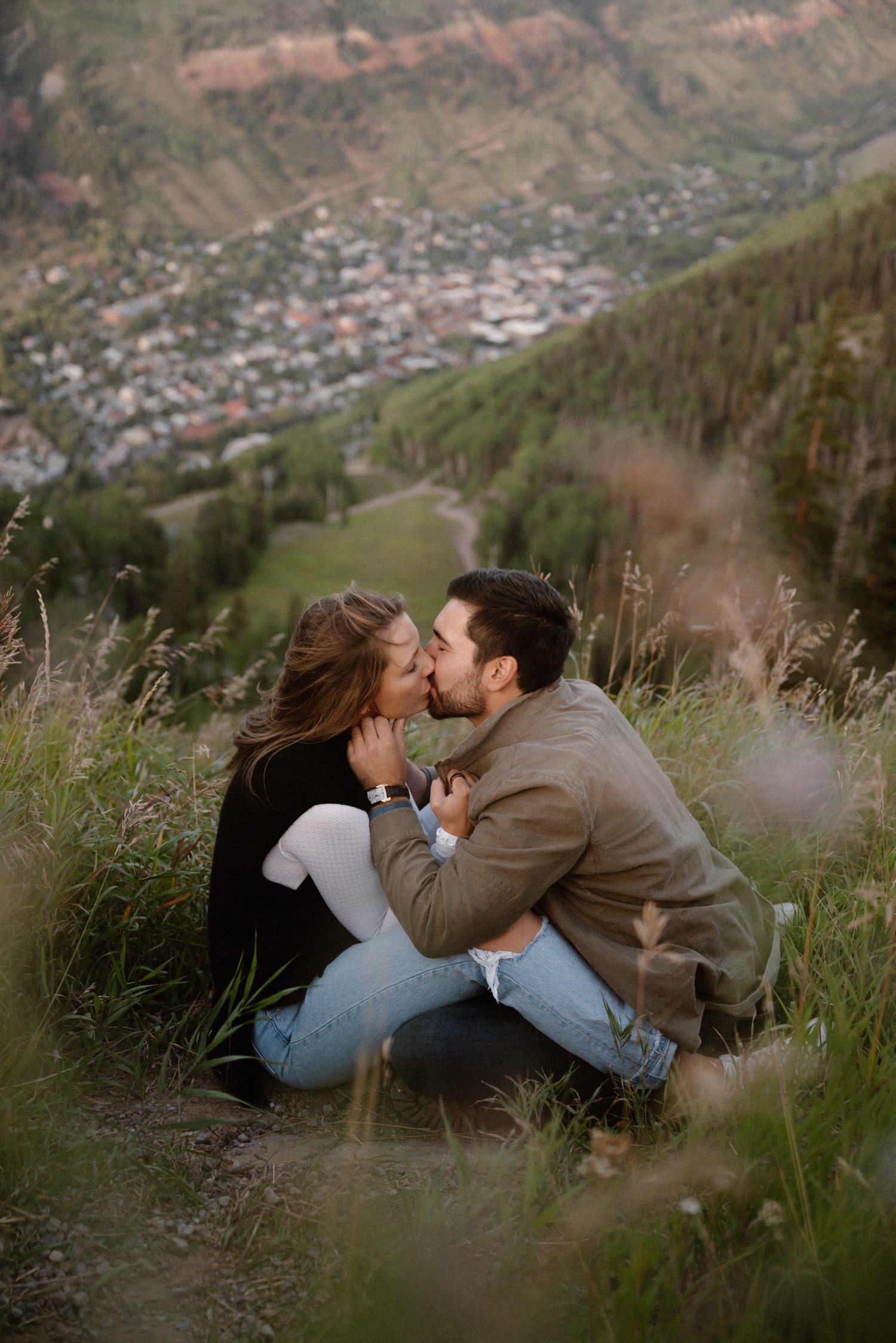 A couple poses for their Telluride engagement session at San Sophia Overlook at the Telluride ski resort. Photo by Durango wedding photographer Ashley Joyce