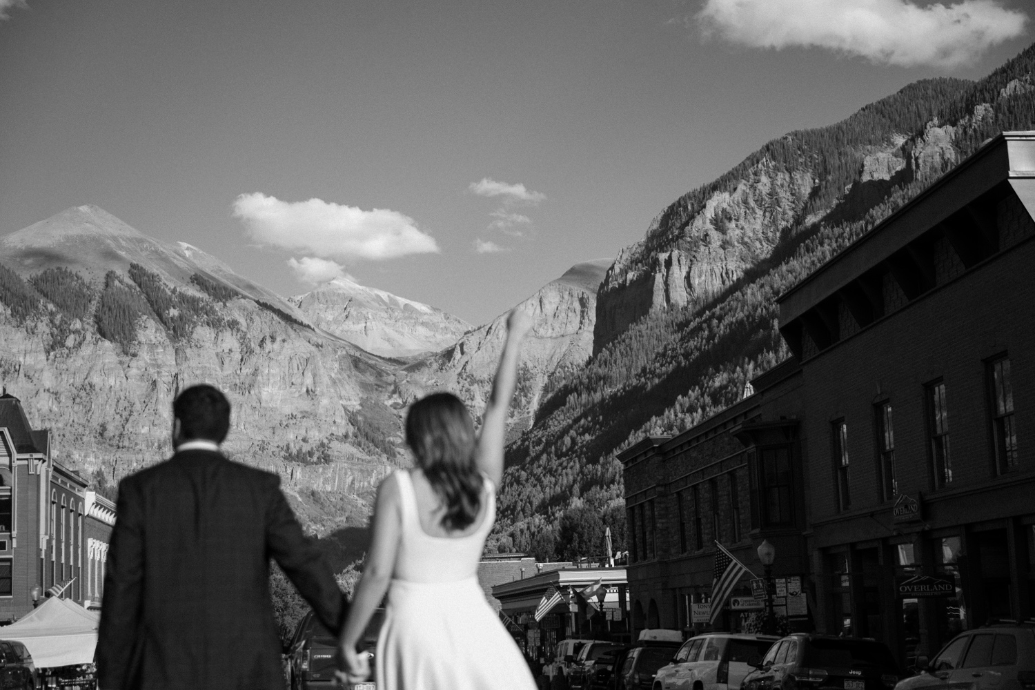 A couple poses for their Telluride engagement session in downtown Telluride, Colorado. Photo by Durango wedding photographer Ashley Joyce