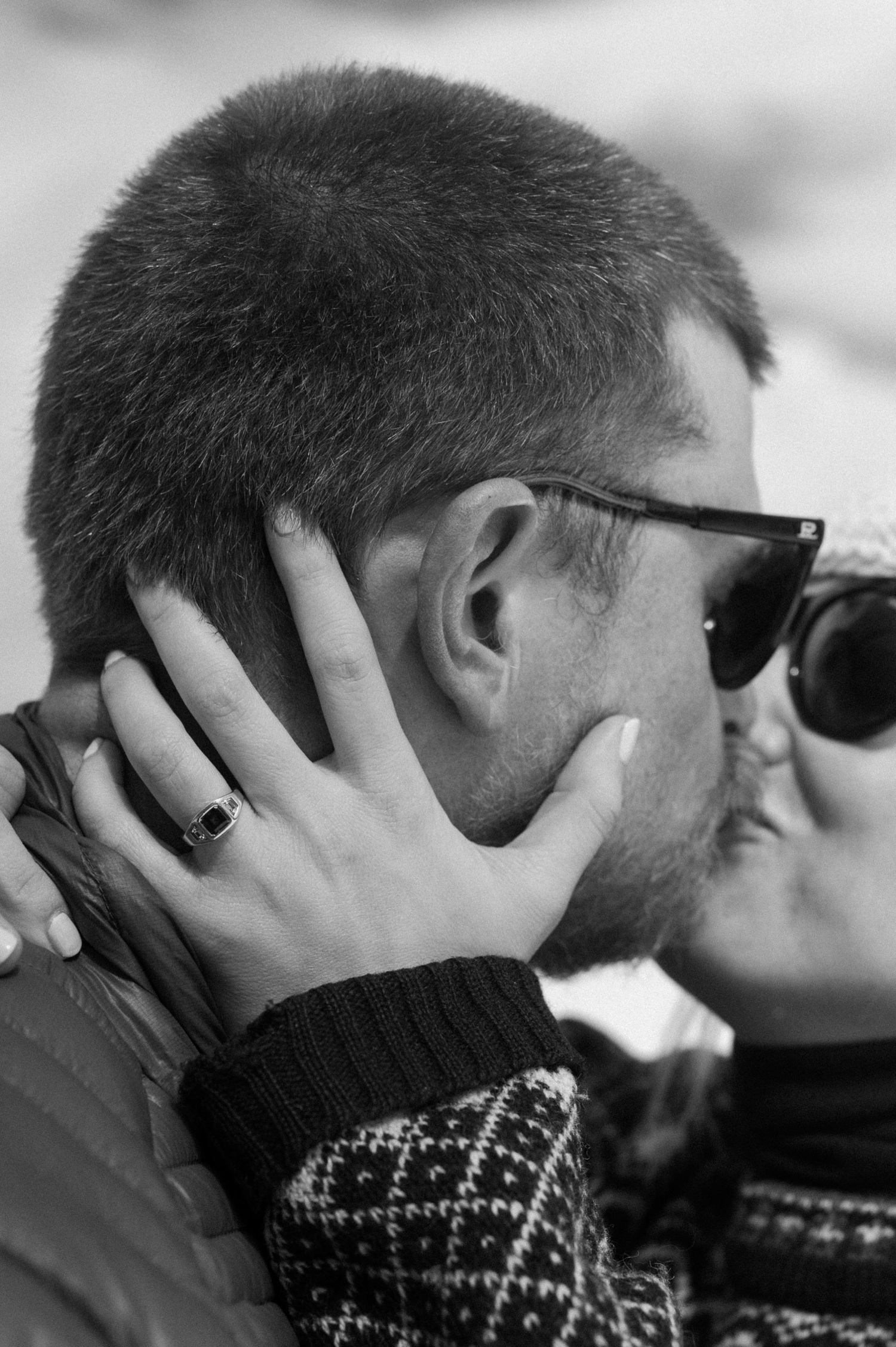 A couple sharing a warm, intimate moment while cross-country skiing in the snow during their winter engagement session in Montrose, Colorado.