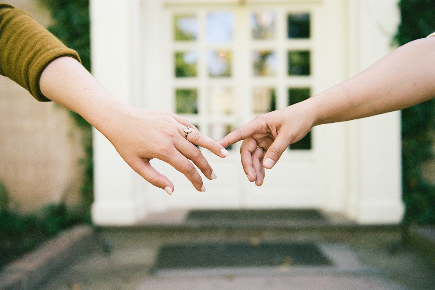 Romantic fall engagement session at Los Poblanos Historic Inn, couple embracing in front of the colorful foliage.