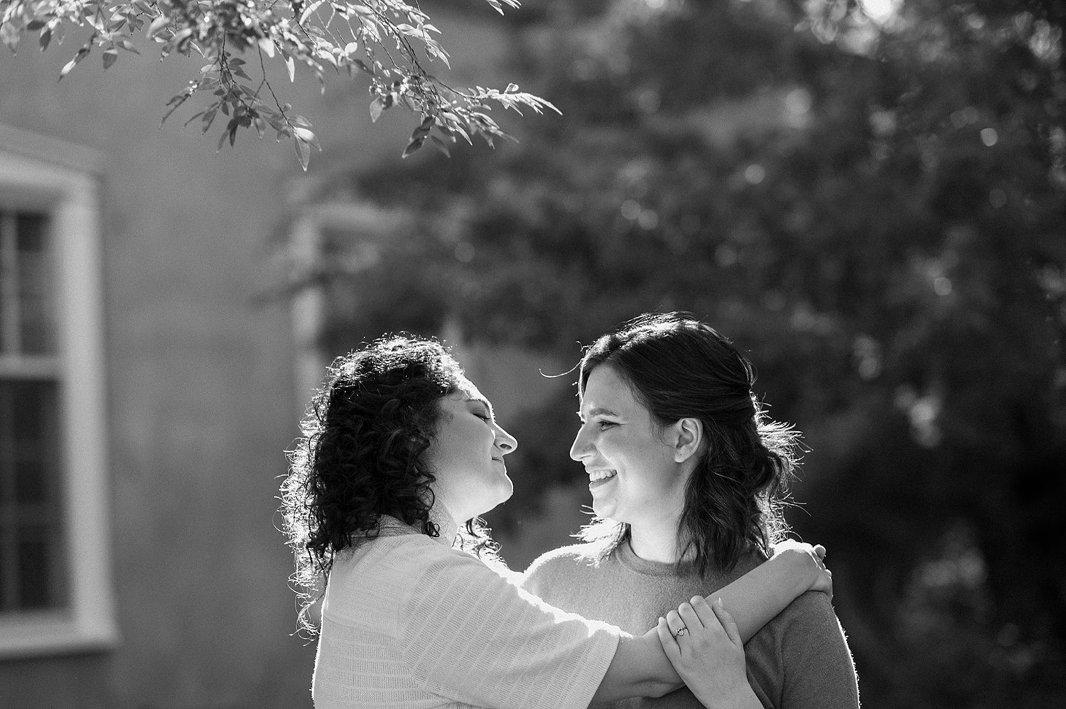 Romantic fall engagement session at Los Poblanos Historic Inn, couple embracing in front of the colorful foliage.